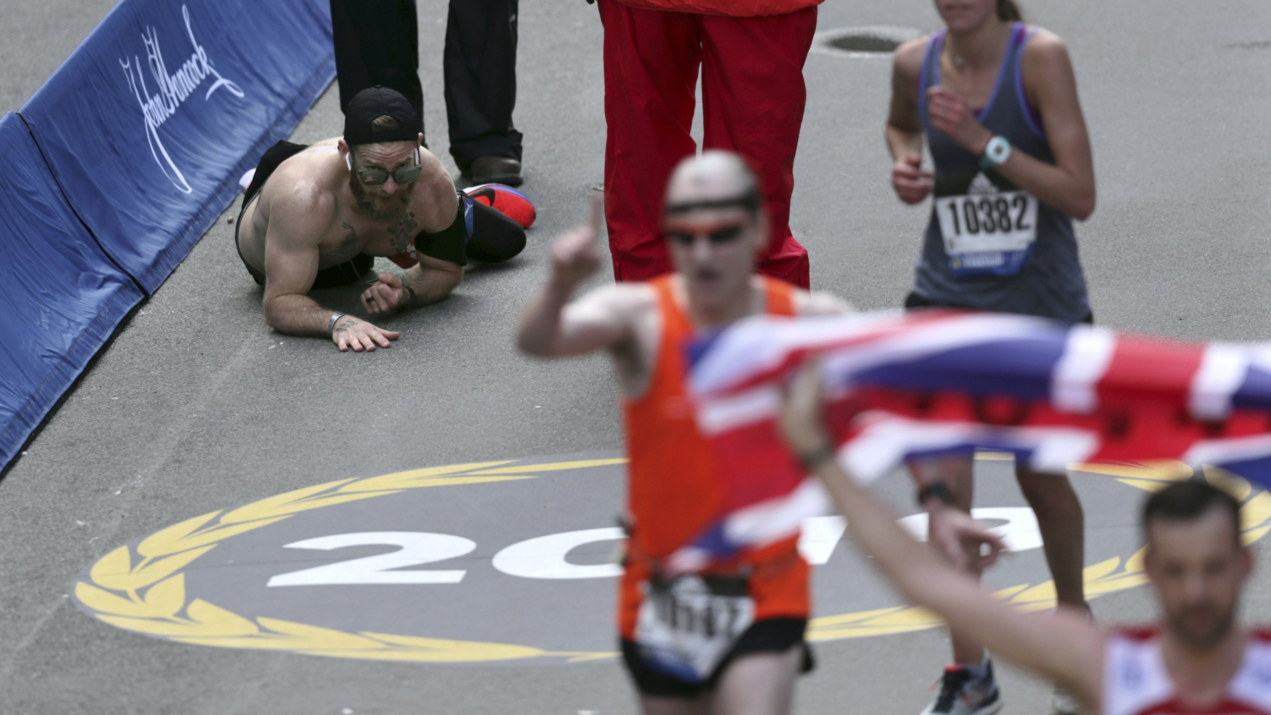 Micah Herndon crawls to the finish line in the 123rd Boston Marathon. He crossed the line at three hours and 38 minutes. (Credit: Charles Krupa/AP)