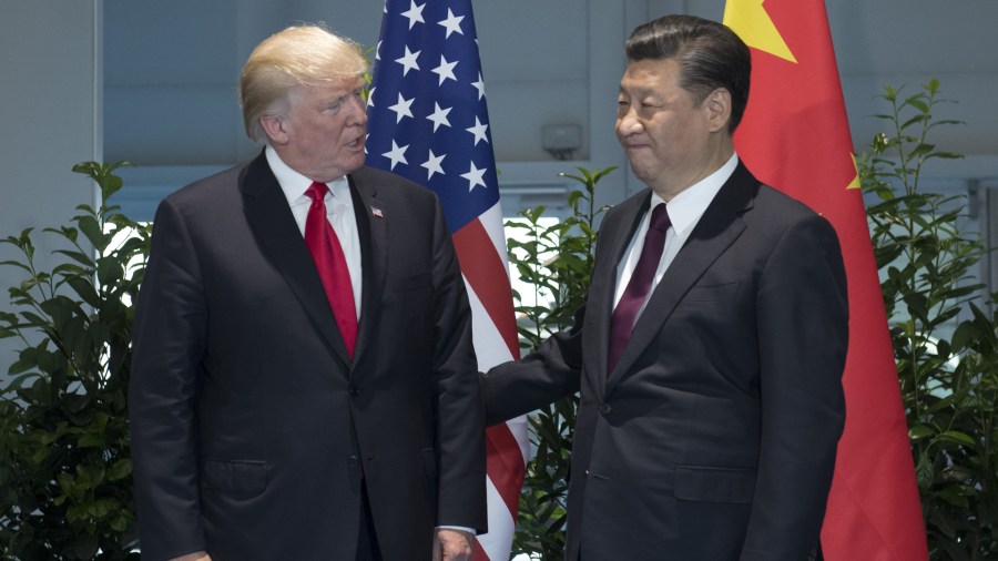 US President Donald Trump and Chinese President Xi Jinping (R) pose prior to a meeting on the sidelines of the G20 Summit in Hamburg, Germany, July 8, 2017. (Credit: SAUL LOEB/AFP/Getty Images)