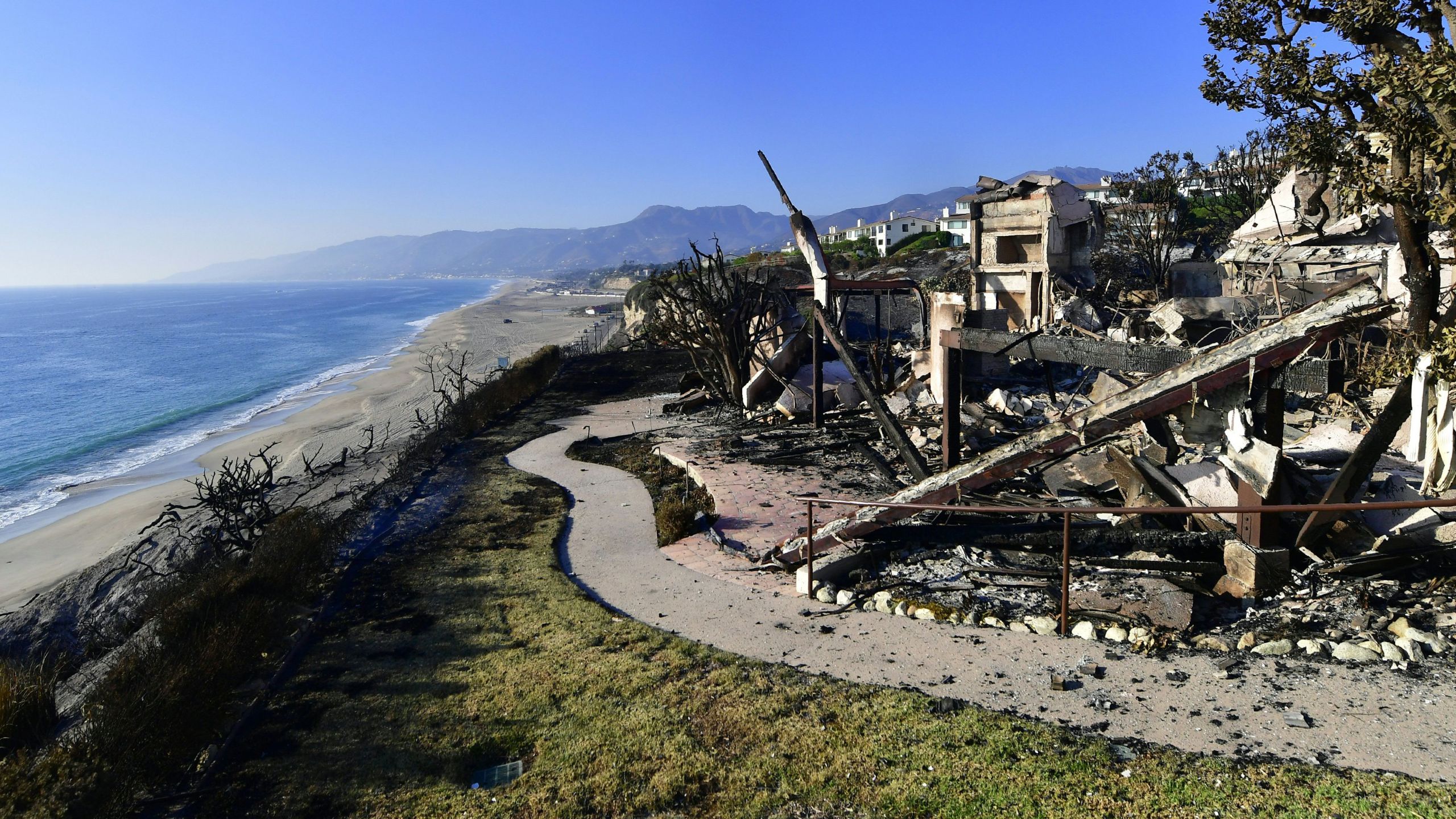 This photo shows the remains of a beachside luxury home along the Pacific Coast Highway community of Point Dume in Malibu on Nov. 11, 2018, as the battle to control the Woolsey Fire continues. (Credit: Frederic J. Brown / AFP / Getty Images)