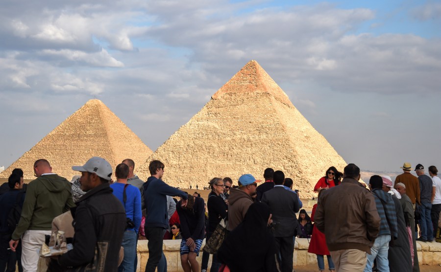 Tourists gather at the Giza pyramids necropolis in Egypt on Dec. 29, 2018, with the pyramids of Khafre and Khufu seen in the background. (Credit: MOHAMED EL-SHAHED/AFP/Getty Images)