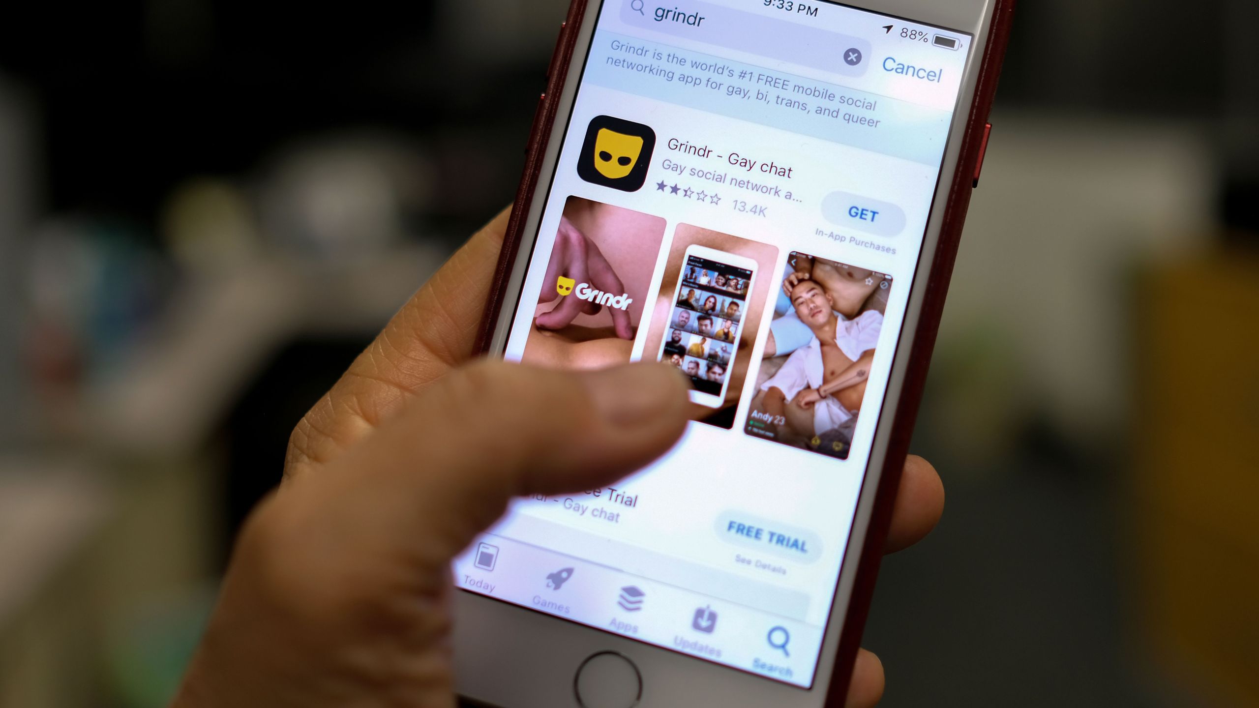 A person looks at the Grindr app in the App Store on an iPhone in Los Angeles on March 27, 2019. (Credit: Chris Delmas / AFP / Getty Images)