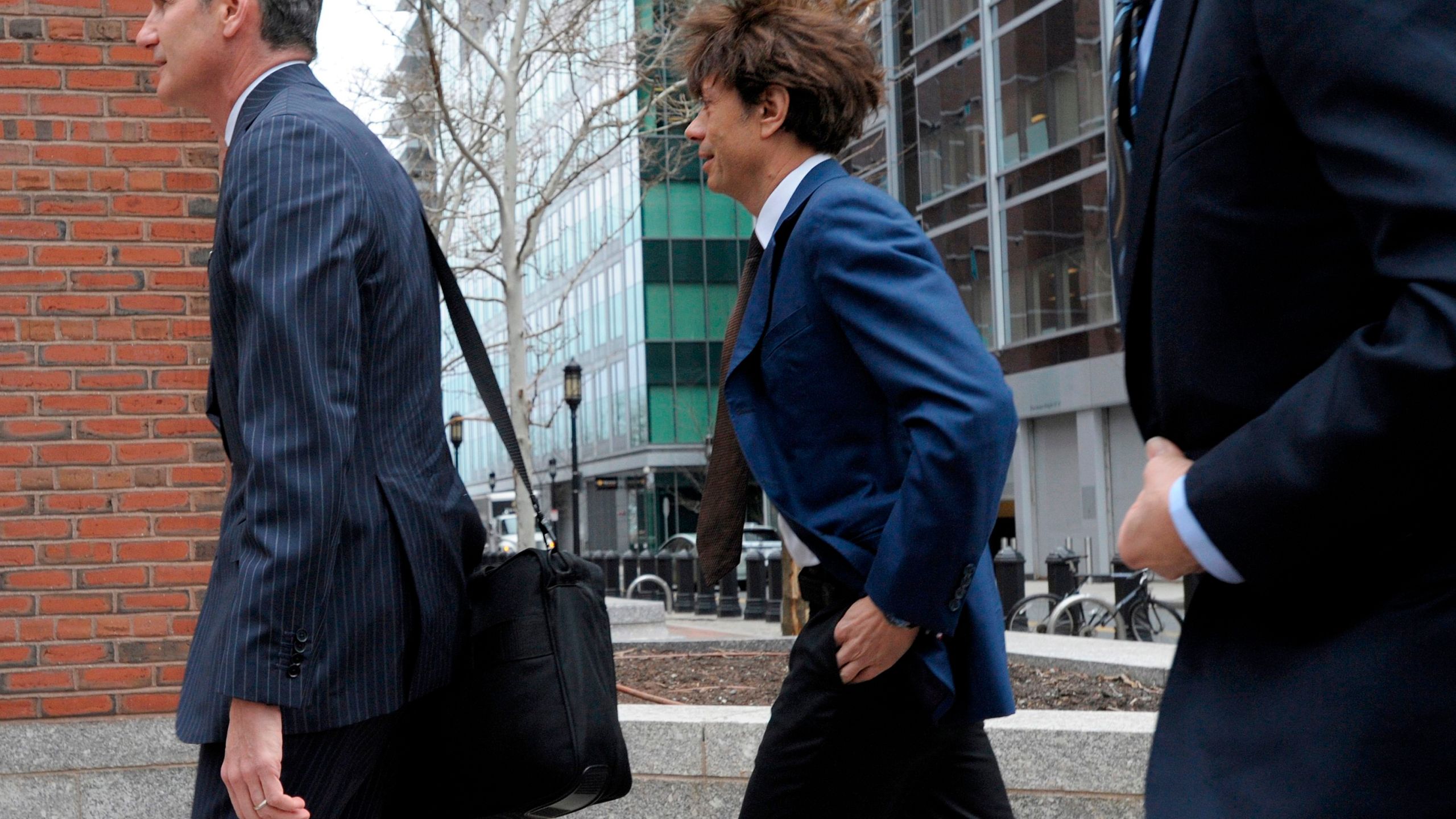 Napa Valley vintner Agustin Huneeus Jr., center, makes his way to the John Joseph Moakley U.S. Courthouse on March 29, 2019 in Boston. (Credit: JOSEPH PREZIOSO/AFP/Getty Images)