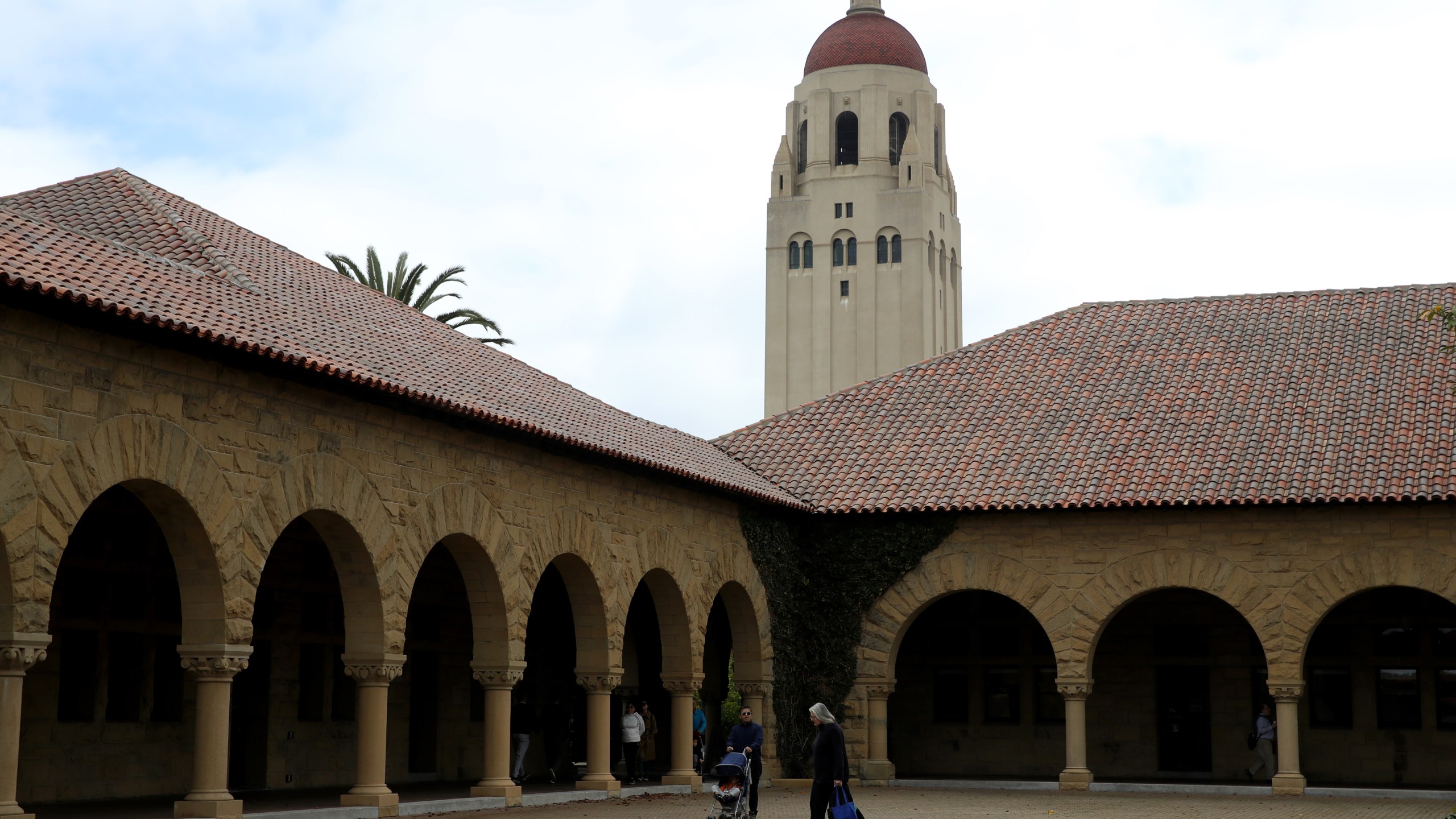 People walk by Hoover Tower on the Stanford University campus on March 12, 2019. (Credit: Justin Sullivan / Getty Images)