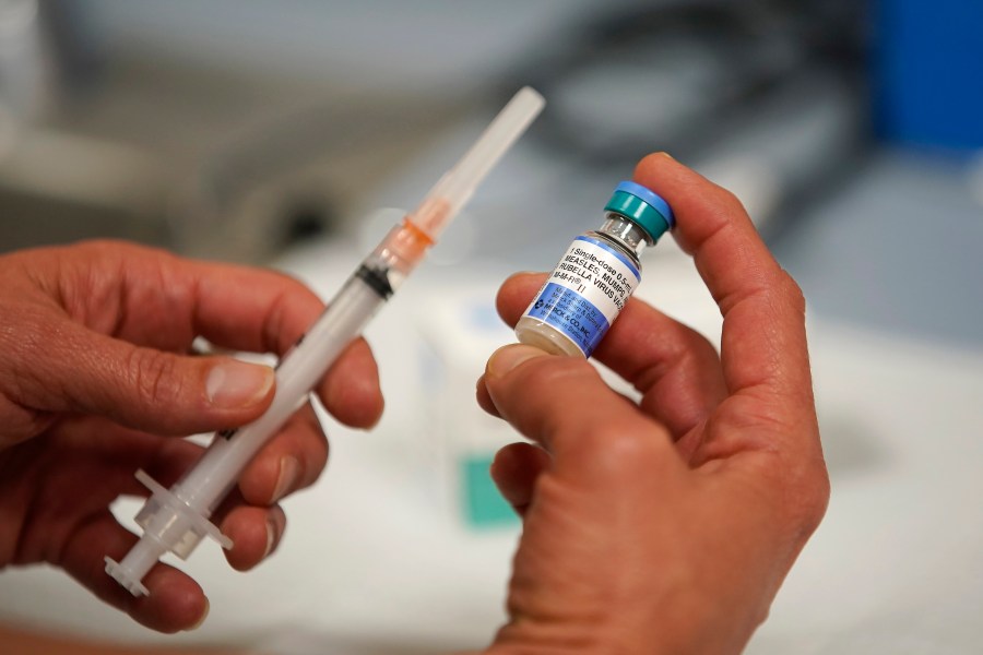 In this photo illustration a one dose bottle of measles, mumps and rubella virus vaccine, made by MERCK, is held up at the Salt Lake County Health Department on April 26, 2019 in Salt Lake City, Utah. (Credit: George Frey/Getty Images)