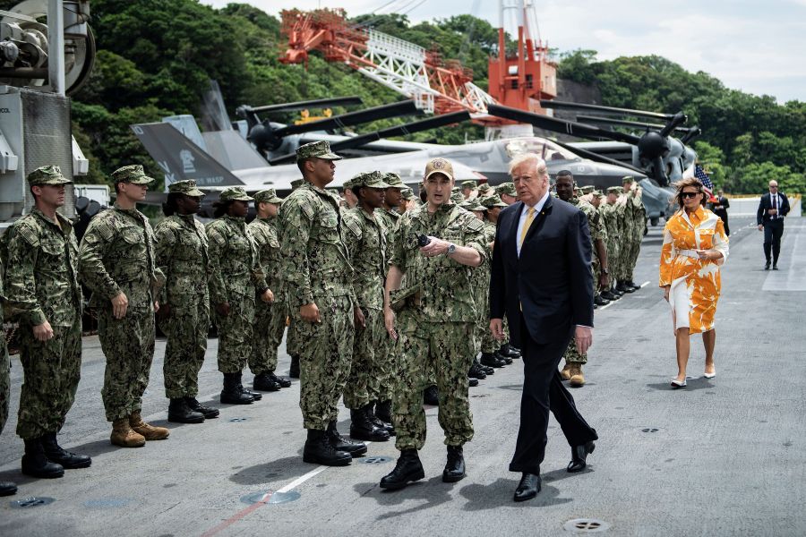 Donald Trump and Melania arrive aboard the amphibious assault ship USS Wasp (LHD 1) to participate in a Memorial Day event in Yokosuka on May 28, 2019. (Credit: BRENDAN SMIALOWSKI/AFP/Getty Images)