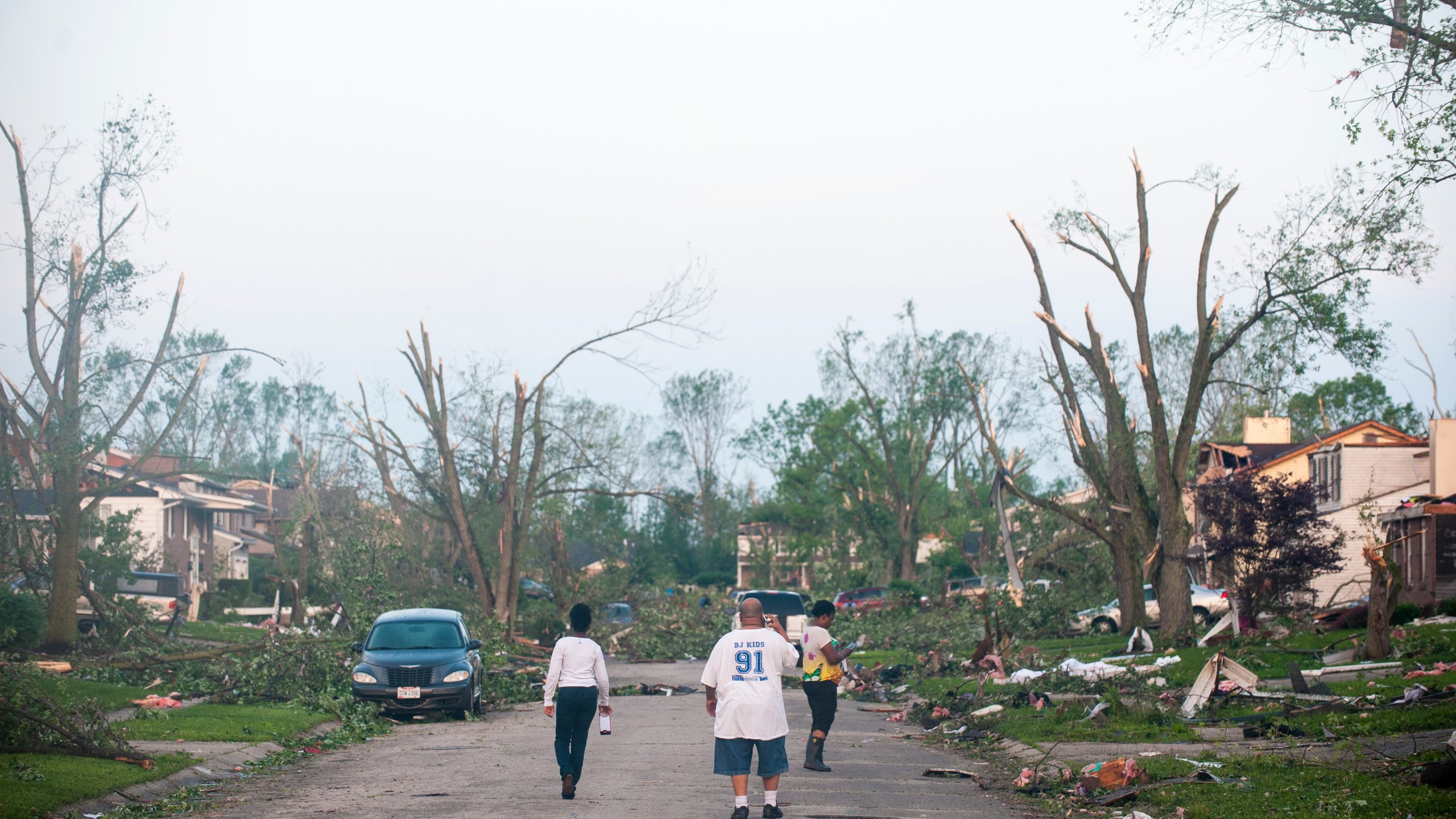 Residents of the West Brook neighborhood emerge from shelter to inspect the damage in their neighborhood after a tornado touched down the morning of May 28, 2019, in Trotwood, Ohio. (Credit: Matthew Hatcher/Getty Images)