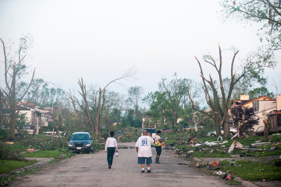 Residents of the West Brook neighborhood emerge from shelter to inspect the damage in their neighborhood after a tornado touched down the morning of May 28, 2019, in Trotwood, Ohio. (Credit: Matthew Hatcher/Getty Images)