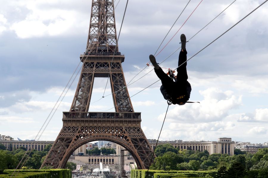 A person rides on a zip-line descending from the second floor of the Eiffel Tower on May 28, 2019 in Paris. (Credit: FRANCOIS GUILLOT/AFP/Getty Images)