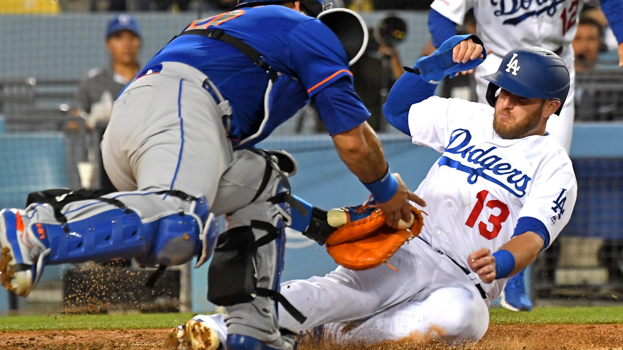 Max Muncy of the Los Angeles Dodgers is safe at home as he beats the tag by Wilson Ramos of the New York Mets, scoring on a single by Justin Turner at Dodger Stadium on May 29, 2019. (Credit: Jayne Kamin-Oncea / Getty Images)