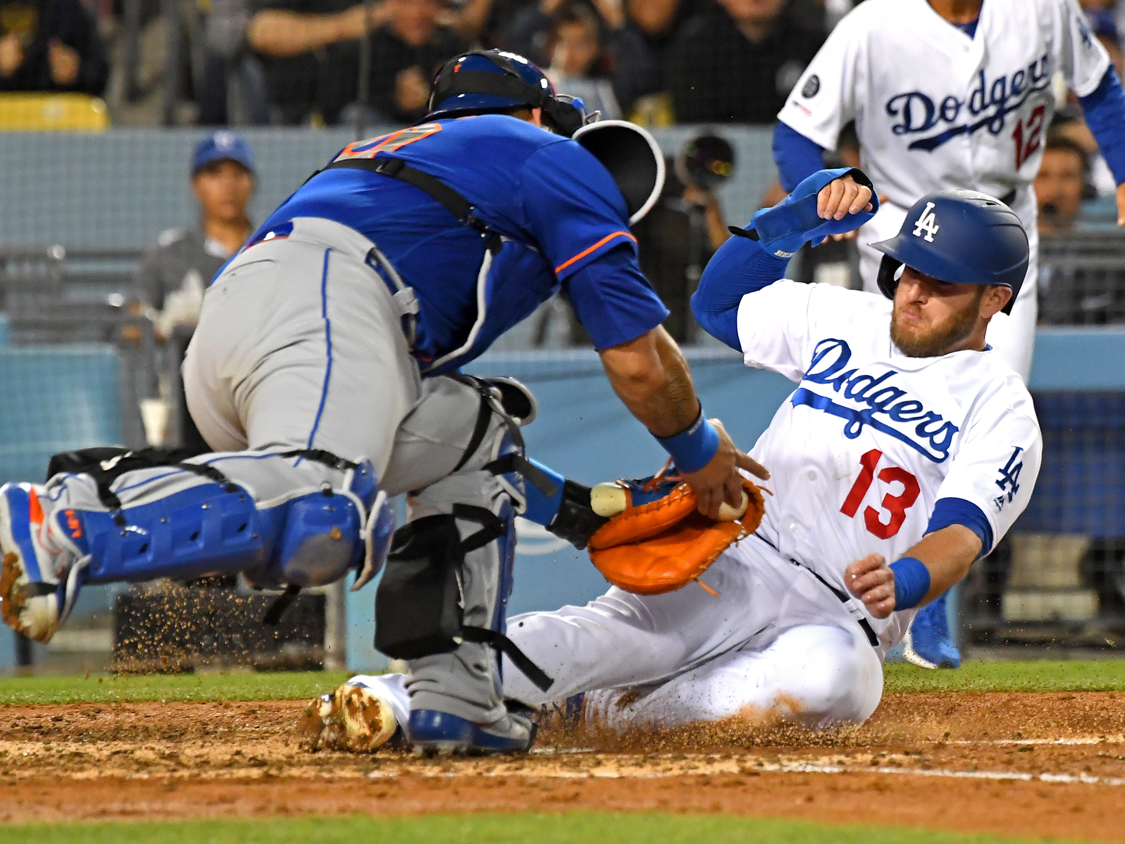 Max Muncy of the Los Angeles Dodgers is safe at home as he beats the tag by Wilson Ramos of the New York Mets, scoring on a single by Justin Turner at Dodger Stadium on May 29, 2019. (Credit: Jayne Kamin-Oncea / Getty Images)