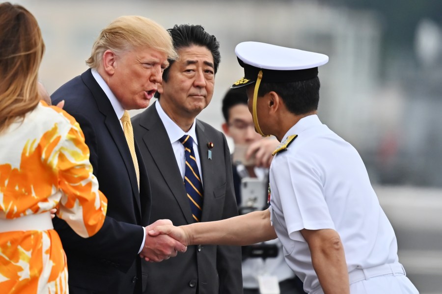 U.S. President Donald Trump handshakes the captain of the ship, Mr. Mizuta, as he leaves the Japan's navy ship Kaga on May 28, 2019, in Yokosuka, Kanagawa, Japan. Trump was on a four-day state visit to Japan, the first official visit of the Reiwa era. (Credit: Charly Triballeau - Pool/Getty Images)