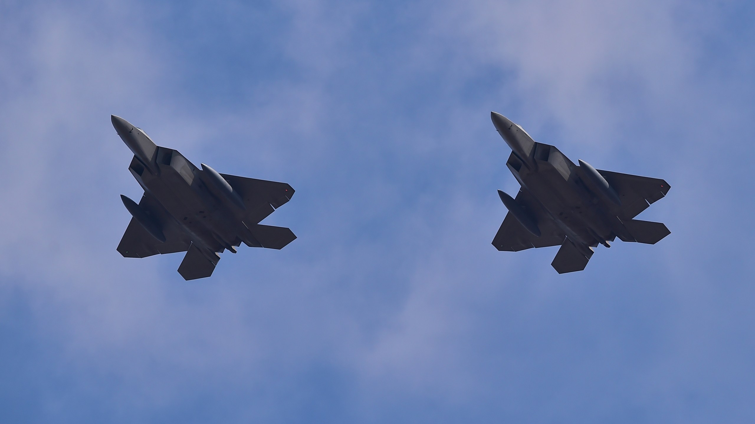 US F-22 stealth fighters fly over Osan Air Base in Pyeongtaek, south of Seoul, on February 17, 2016. (Credit: JUNG YEON-JE/AFP/Getty Images)