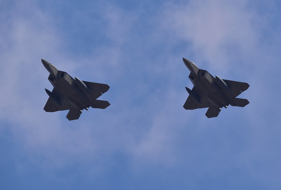 US F-22 stealth fighters fly over Osan Air Base in Pyeongtaek, south of Seoul, on February 17, 2016. (Credit: JUNG YEON-JE/AFP/Getty Images)