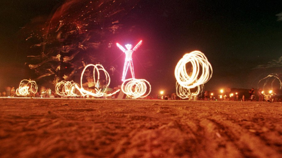 Dancers at the "Burning Man" festival create patterns with fireworks in the Black Rock Desert of Nevada just prior to burning a five-story, neon-lit effigy of a man on the last night of the week-long festival 06 September. (Credit: MIKE NELSON/AFP/Getty Images)