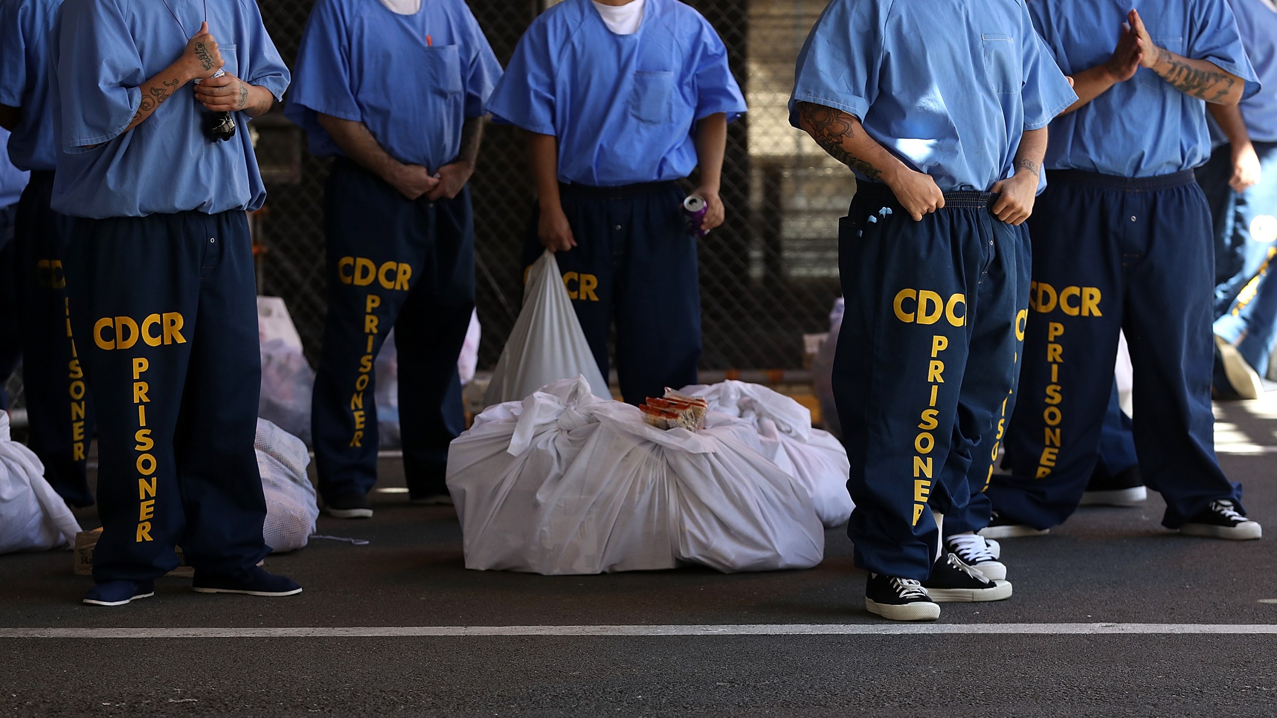 Inmates at San Quentin State Prison wait in line on Aug. 15, 2016. (Justin Sullivan / Getty Images)