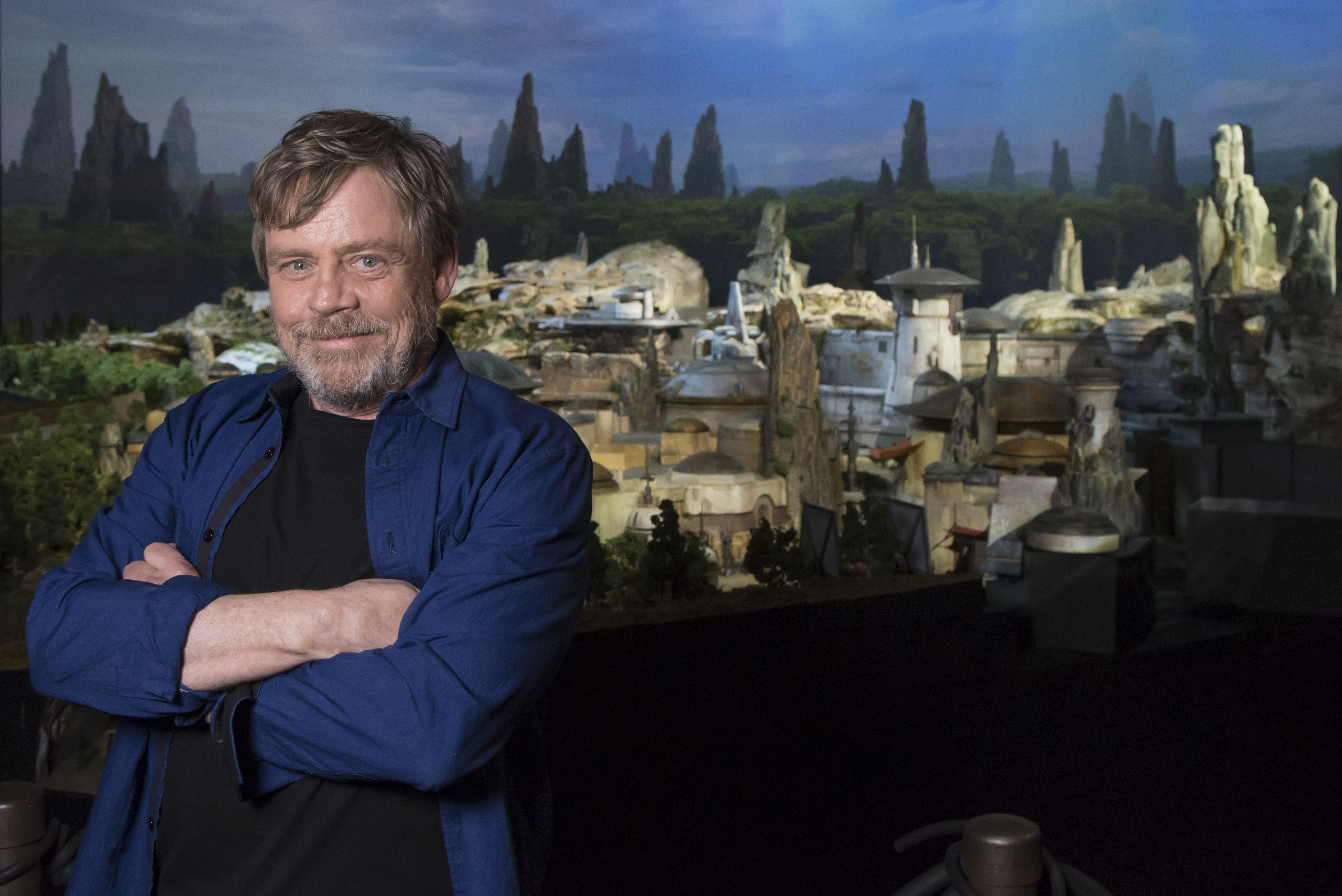 In this handout photo provided by Disney Parks, actor Mark Hamill visits Galaxy's Edge, the new Star Wars-themed land, at Disney Parks on July 14, 2017 in Anaheim, California. (Credit: Joshua Sudock/Disneyland Resort via Getty Images)