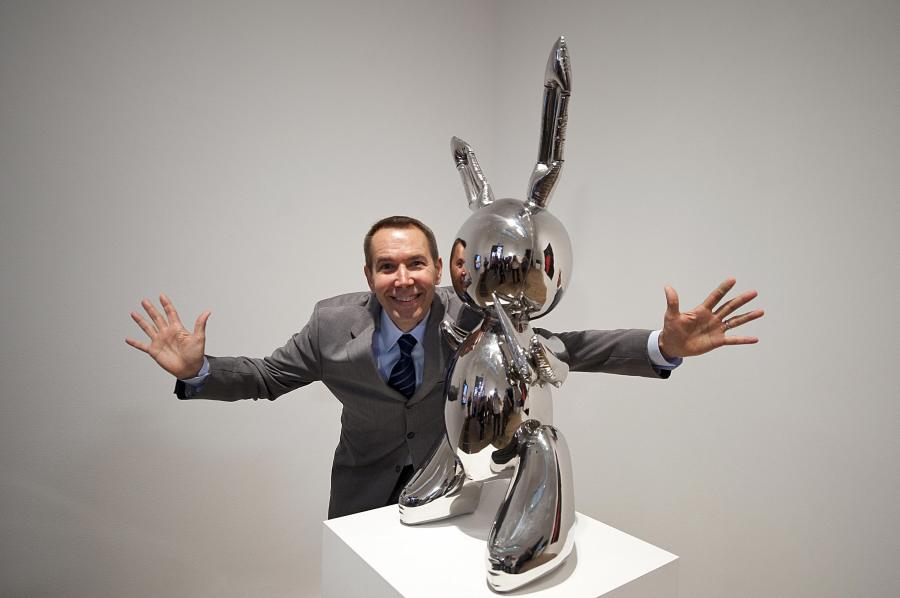 Artist Jeff Koons poses for photographs with his work of art entitled 'Rabbit 1986' during the press view of the 'Pop Life, Art In A Material World' exhibition at the Tate Modern, in London, on September 29, 2009. (Credit: BEN STANSALL/AFP/Getty Images)