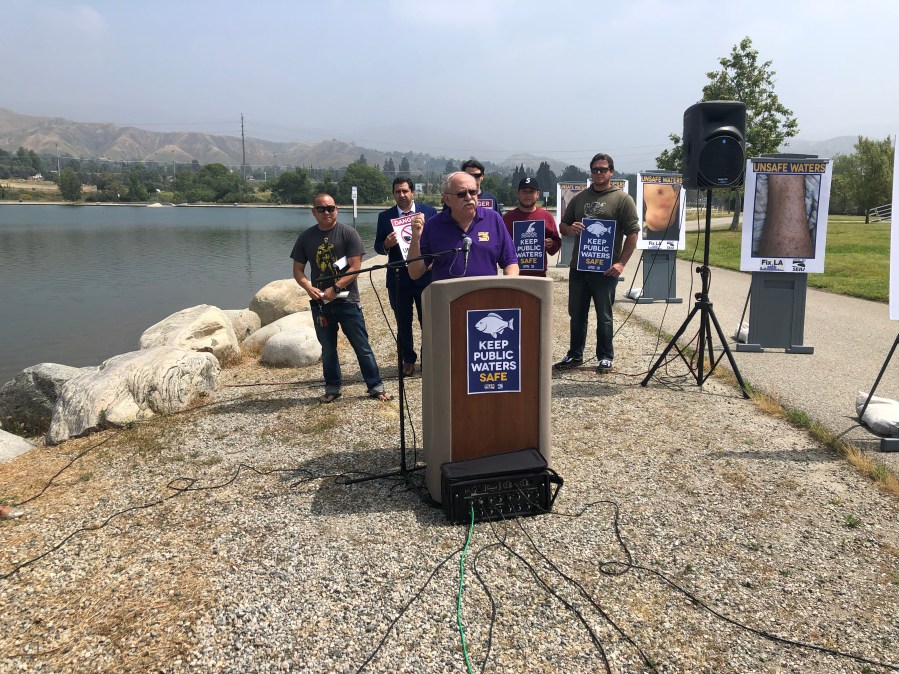 Los Angeles city lifeguards and San Fernando Valley community leaders hold a press conference to discuss concerns over water quality at the Hansen Dam Recreation Lake on May 14, 2019. (Credit: KTLA)