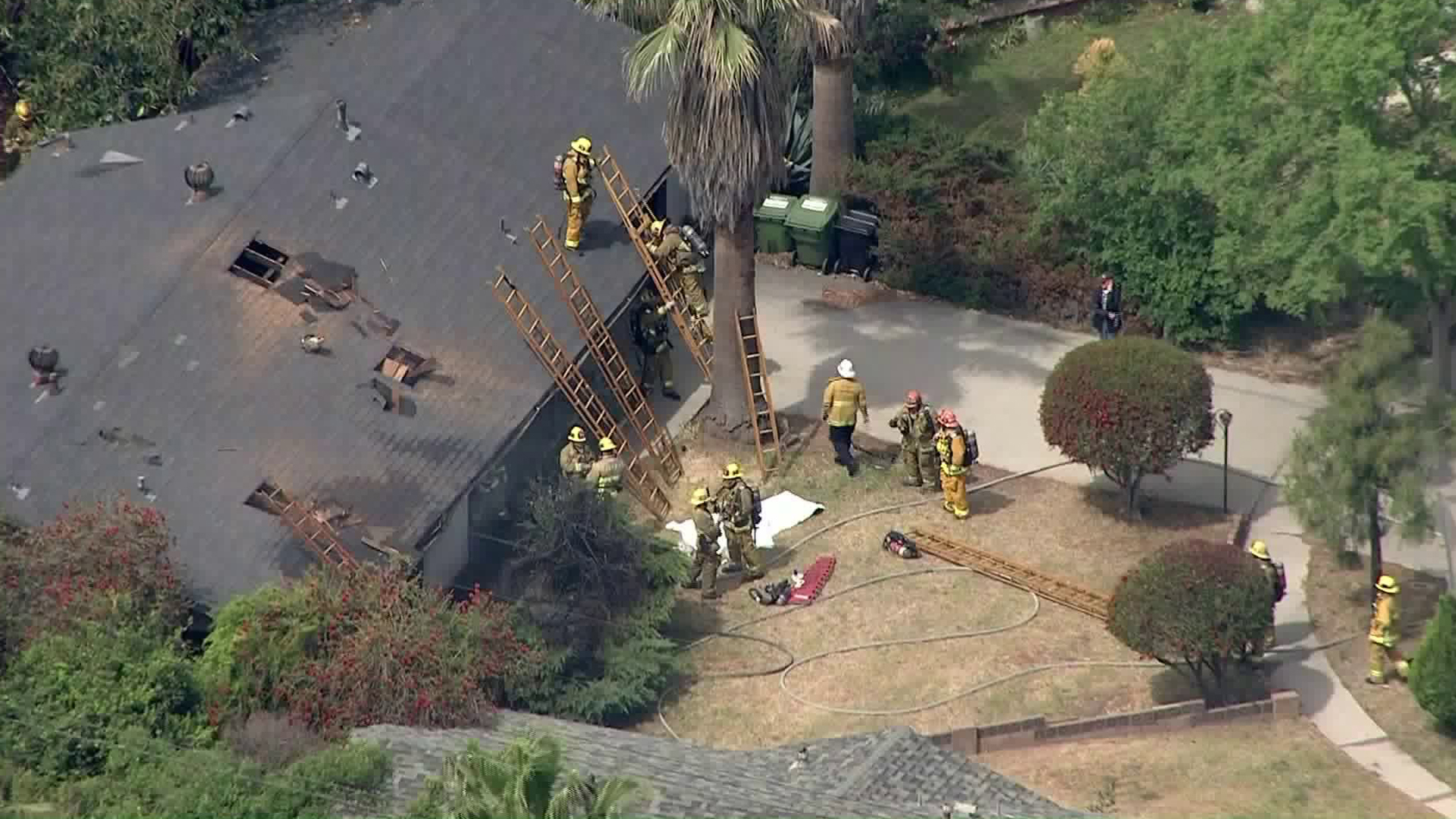 A white sheet covers the body of a man killed in a Lake View Terrace house fire on May 2, 2019. (Credit: KTLA)