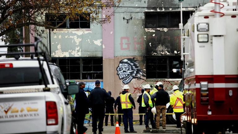 A drone flies over investigators outside the Oakland warehouse where at least 36 people died on Dec. 2, 2016. (Credit: Jay L. Clendenin/Los Angeles Times)