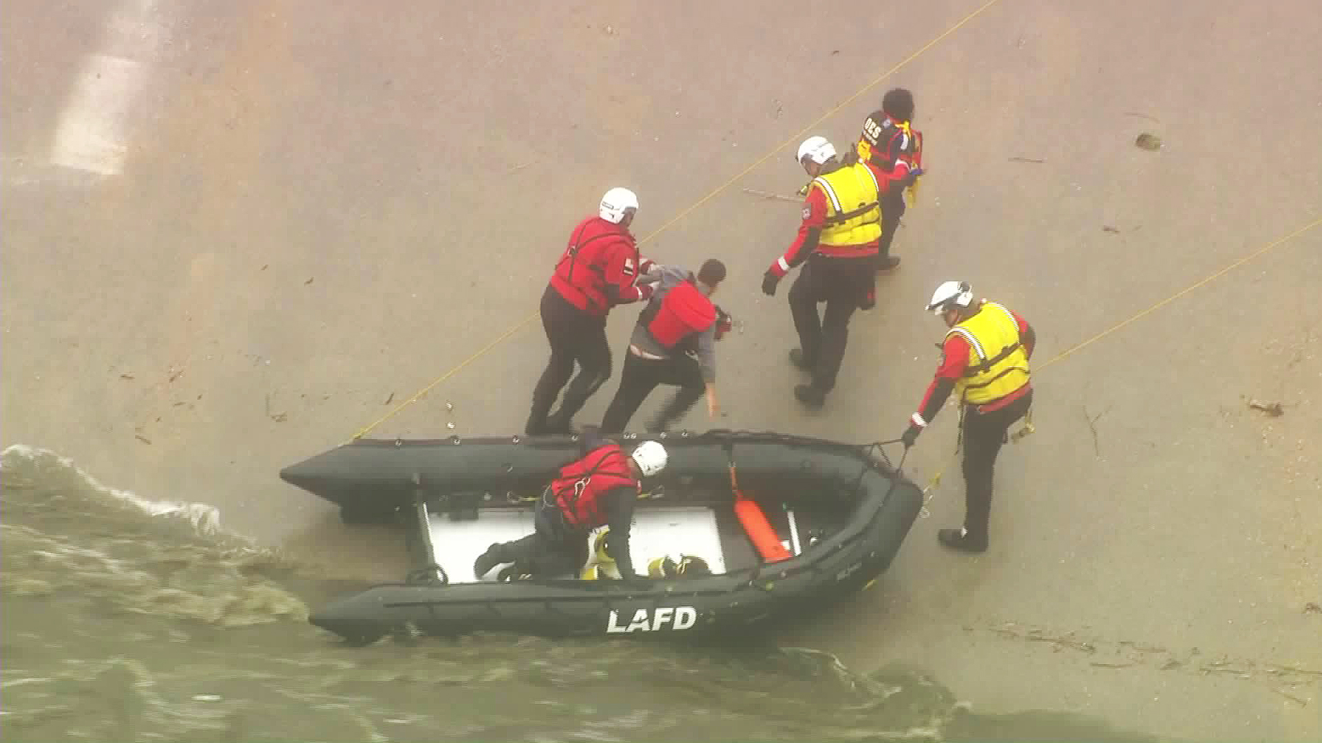 Crews rescue two people from the Los Angeles River on May 16, 2019. (Credit: KTLA)