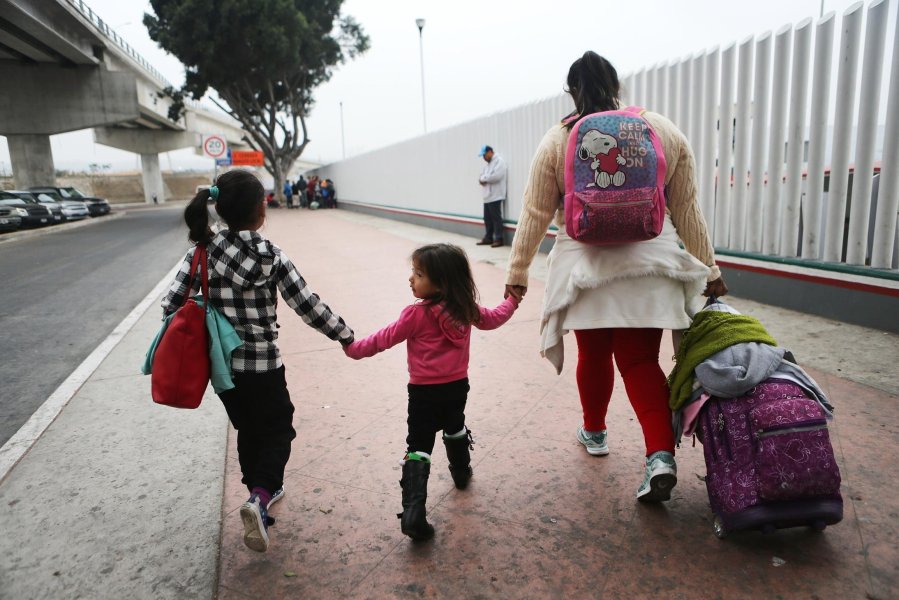 A migrant mother walks with her two daughters on their way to cross the port of entry into the U.S. in this June 2018 photo. A 10-year-old Salvadoran girl who died in Department of Health and Human Services custody last September was identified Friday by a US Customs and Border Protection official as Darlyn Cristabel Cordova-Valle. (Credit: CNN)