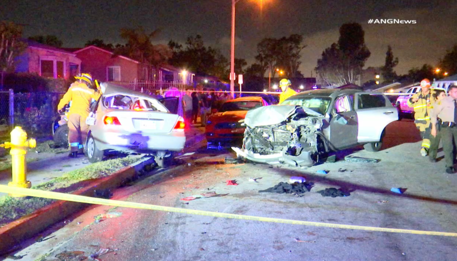 Officers assess two mangled vehicles that had collided in Willowbrook on May 11, 2019. (Credit: ANG News)