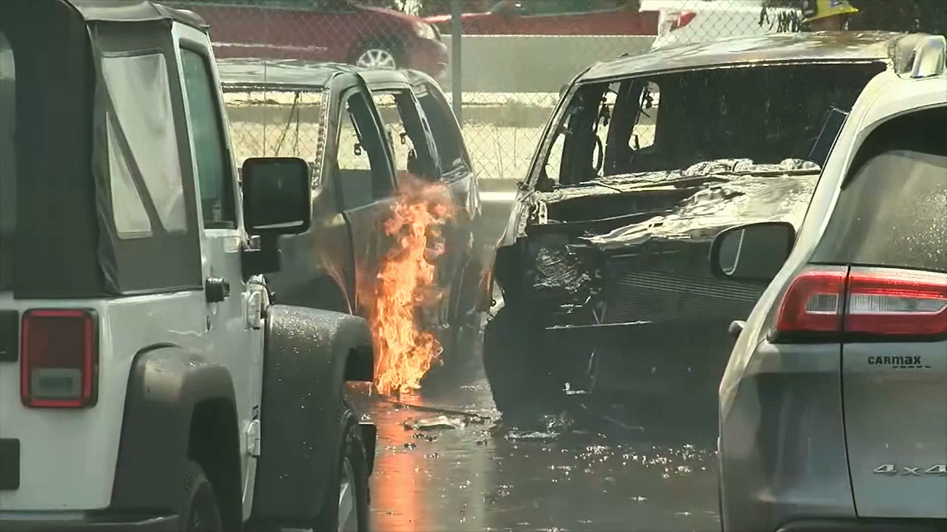 A brush fire spread from Highway 99 to a CarMax lot in Bakersfield on June 14, 2019. (Credit: KGET via CNN)