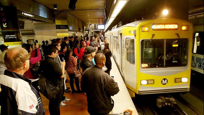 A crowd of people wait for an Expo Line train at the 7th Street / Metro Center station in downtown Los Angeles in 2016. (Credit: Luis Sinco / Los Angeles Times)