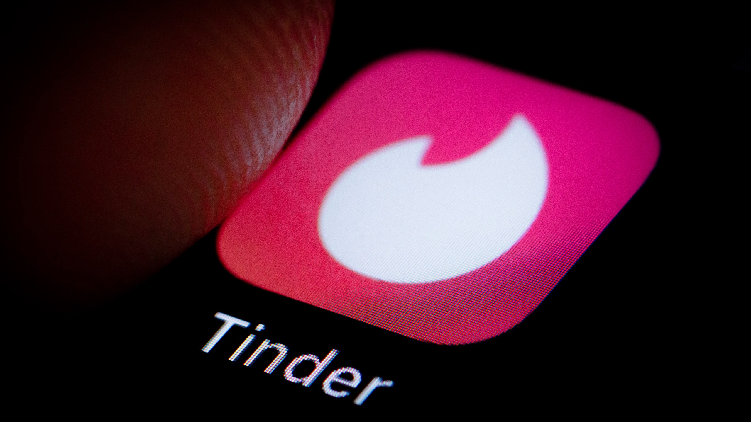 The Logo of location-based social search mobile app Tinder is displayed on a smartphone on October 05, 2018. (Credit: Thomas Trutschel/Photothek via Getty Images)