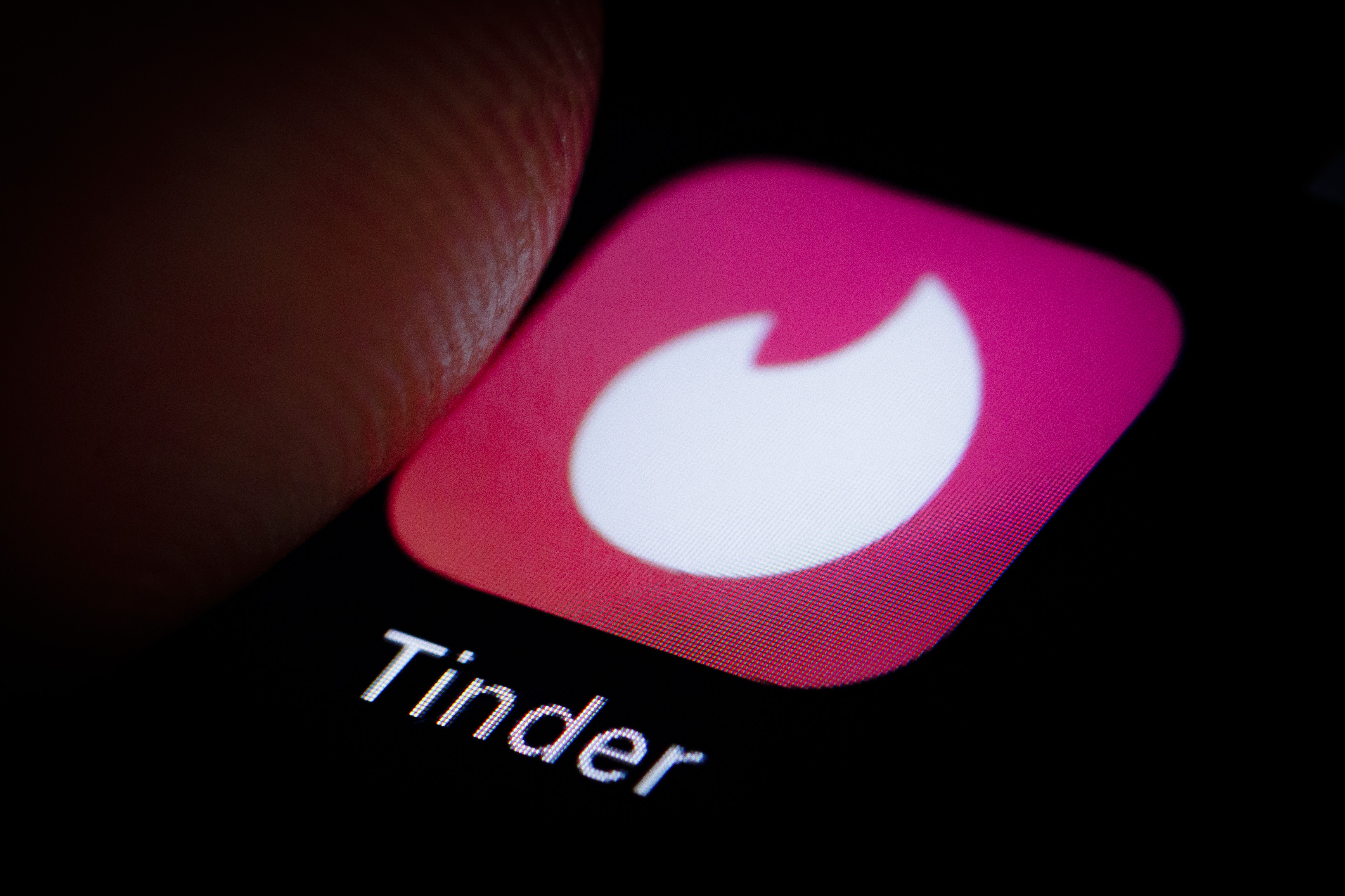 The Logo of location-based social search mobile app Tinder is displayed on a smartphone on October 05, 2018. (Credit: Thomas Trutschel/Photothek via Getty Images)