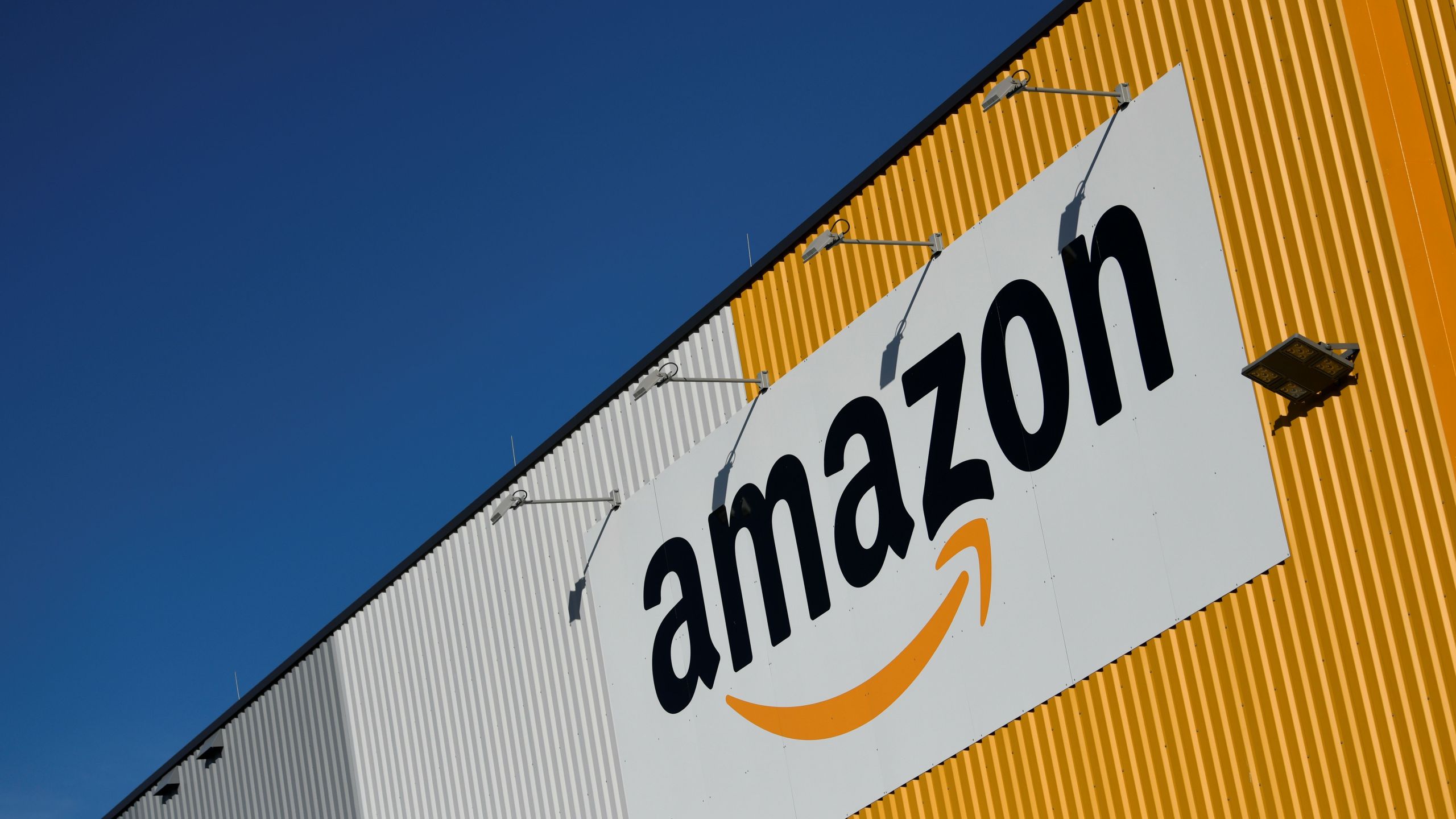 A picture taken on Nov. 8, 2018 shows the Amazon logo displayed outside the group's distribution center in Dortmund, Germany. (Credit: INA FASSBENDER/AFP/Getty Images)