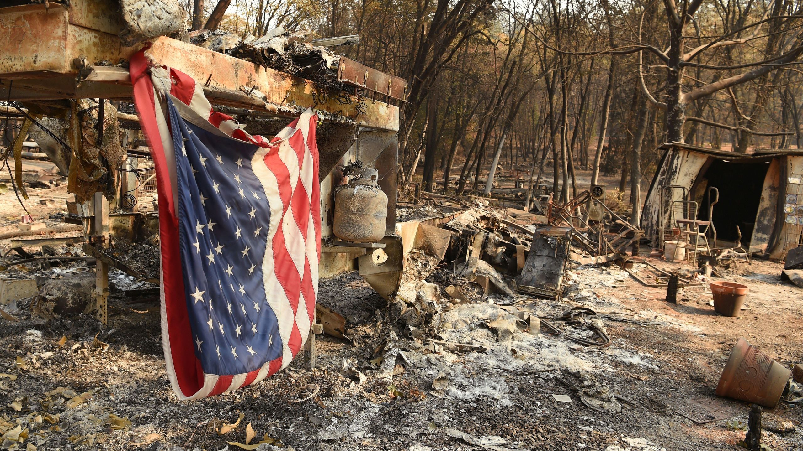 An American flag hangs at a burned out mobile home park in Paradise, California on Nov. 18, 2018. (JOSH EDELSON/AFP/Getty Images)