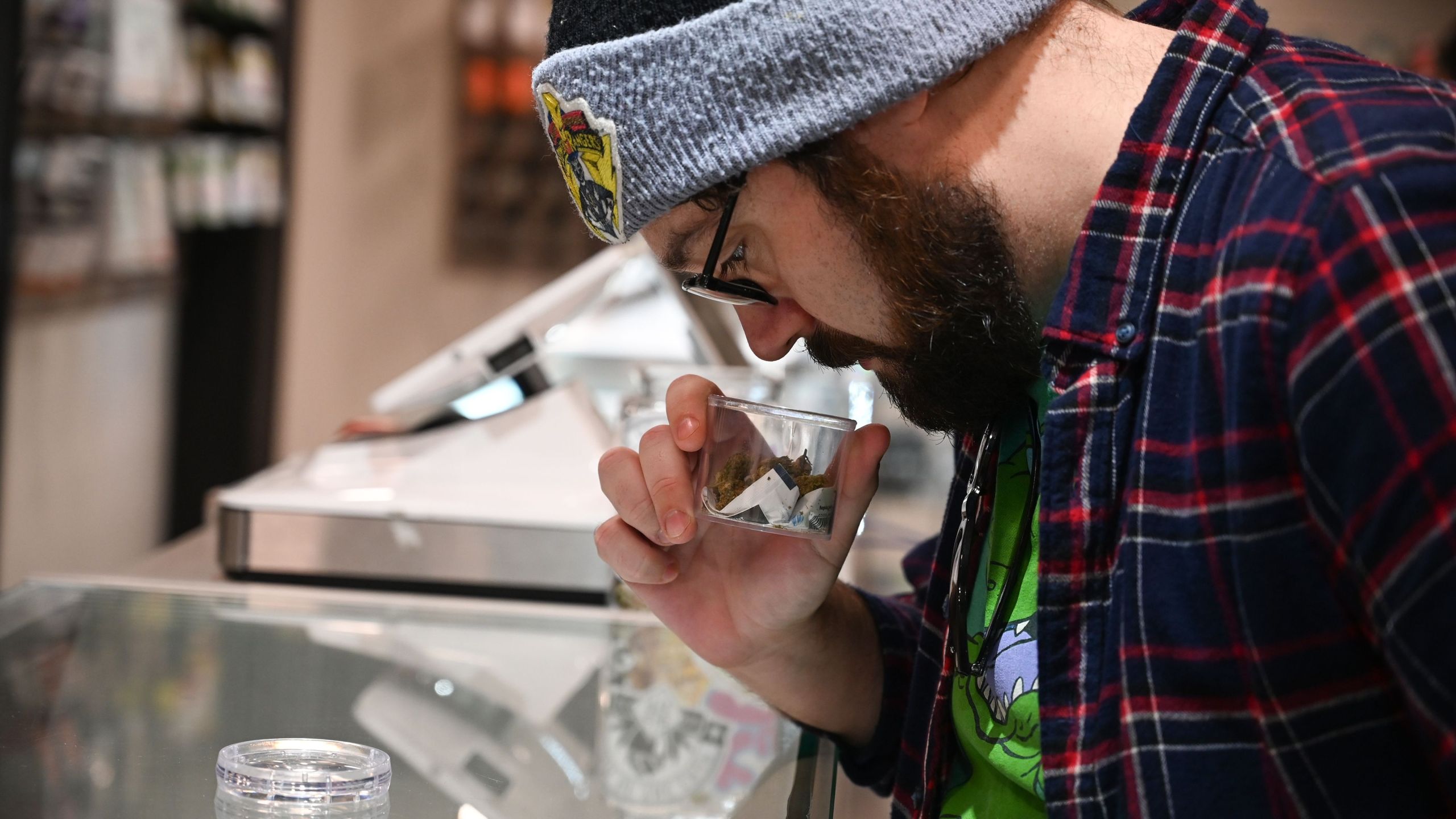 Cannabis tourist Dan Chlebanowski smells marijuana for sale at a dispensary in Los Angeles on Jan. 24, 2019. (Credit: Robyn Beck / AFP / Getty Images)