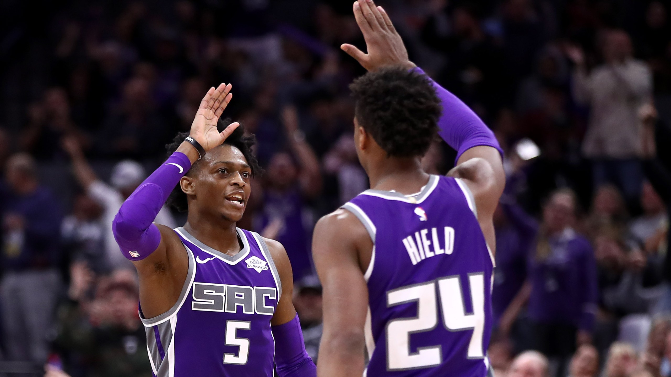 De'Aaron Fox #5 high-fives Buddy Hield #24 of the Sacramento Kings during their game against the Portland Trail Blazers at Golden 1 Center on Jan. 14, 2019, in Sacramento. (Credit: Ezra Shaw/Getty Images)