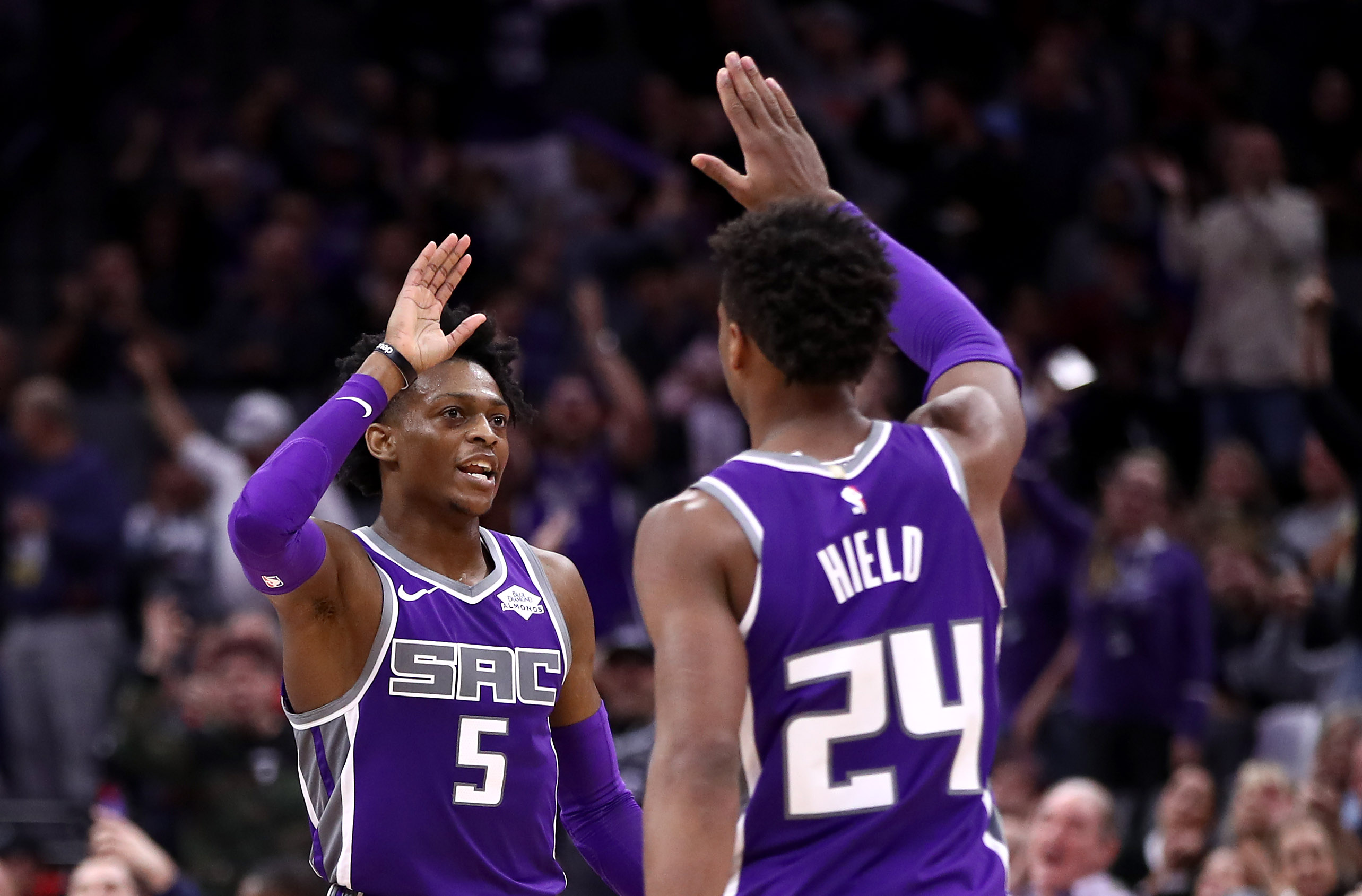 De'Aaron Fox #5 high-fives Buddy Hield #24 of the Sacramento Kings during their game against the Portland Trail Blazers at Golden 1 Center on Jan. 14, 2019, in Sacramento. (Credit: Ezra Shaw/Getty Images)