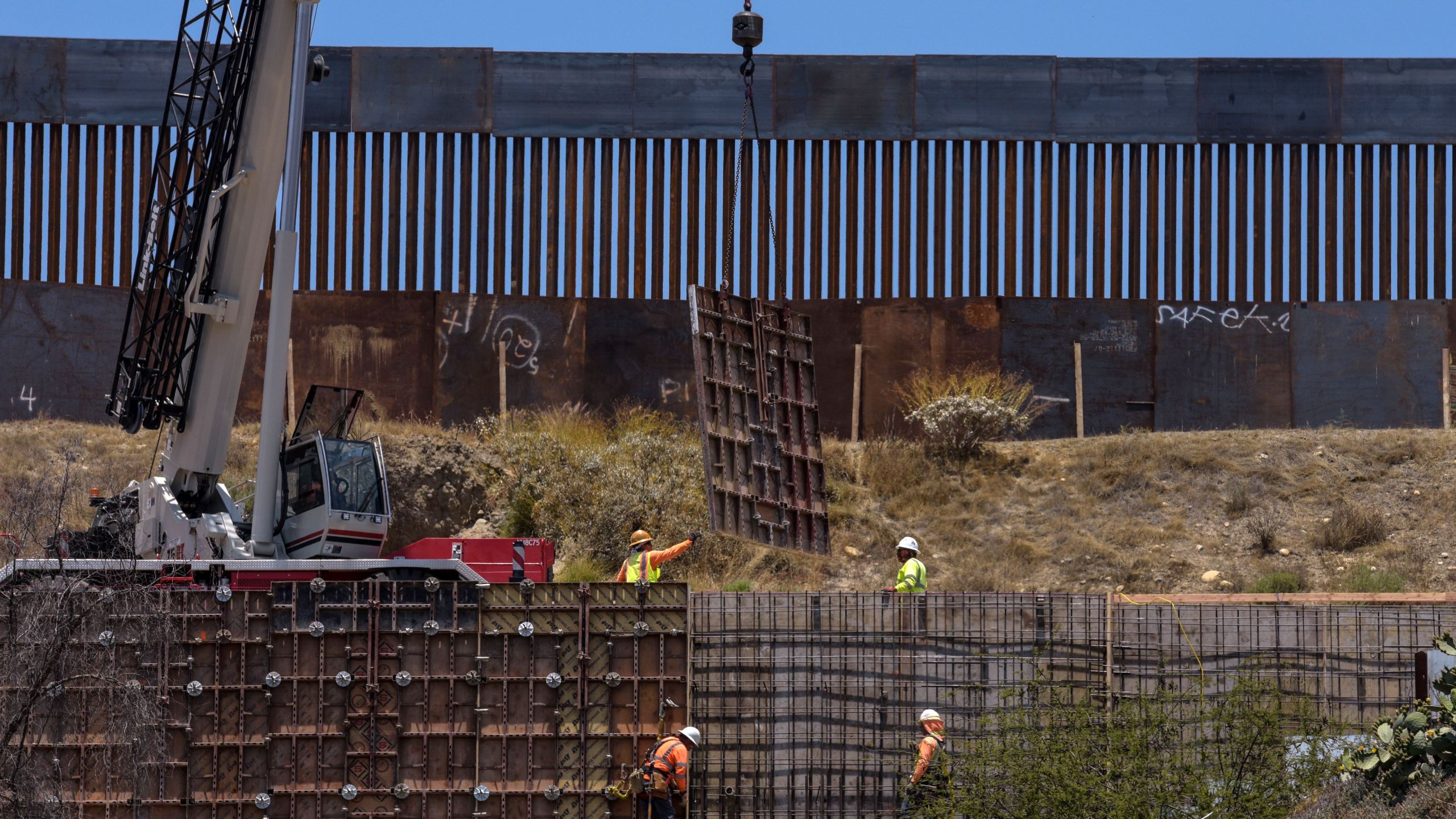 Workers set up a second layer of wall along the U.S.-Mexico border in Tijuana on June 18, 2019. (Credit: Agustin Paullier / AFP / Getty Images)