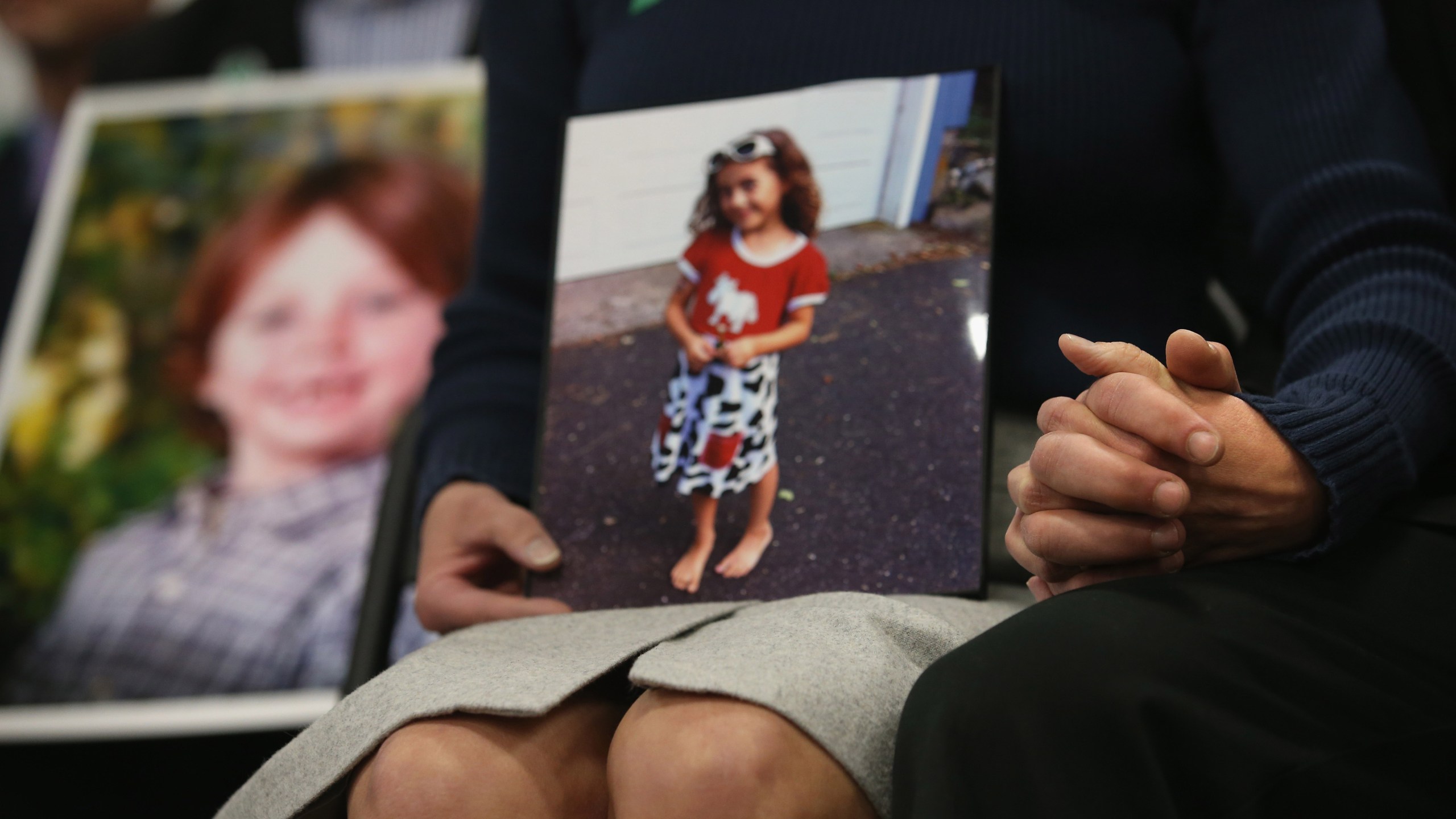 Parents of the Sandy Hook Elementary shooting victims hold hands on the one-month anniversary the massacre on Jan. 14, 2013 in Newtown, Connecticut. (Credit: John Moore/Getty Images)