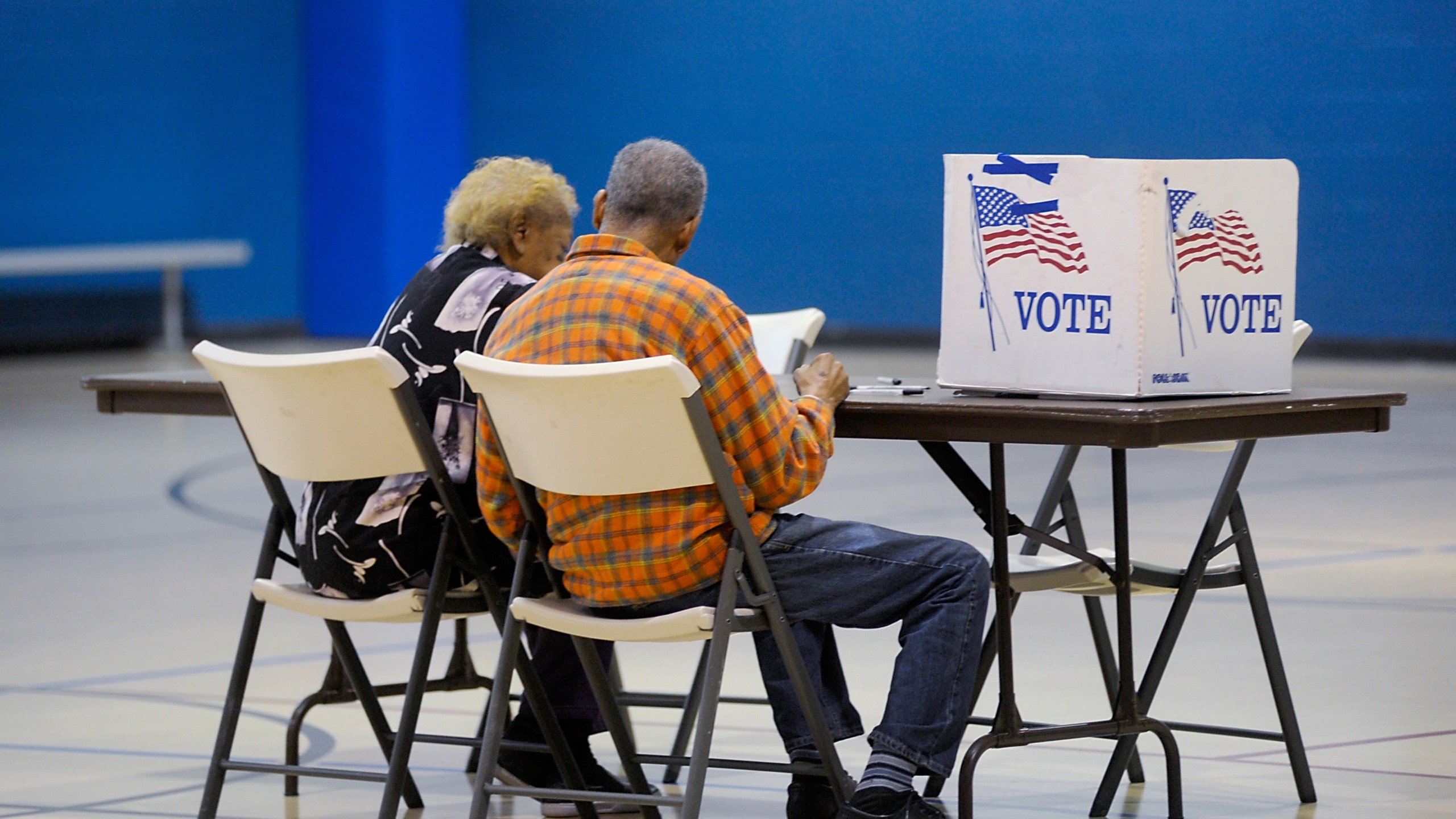 An elderly couple reads a ballot prior to voting on Nov. 8, 2016, in Durham, North Carolina. (Credit: Sara D. Davis/Getty Images)