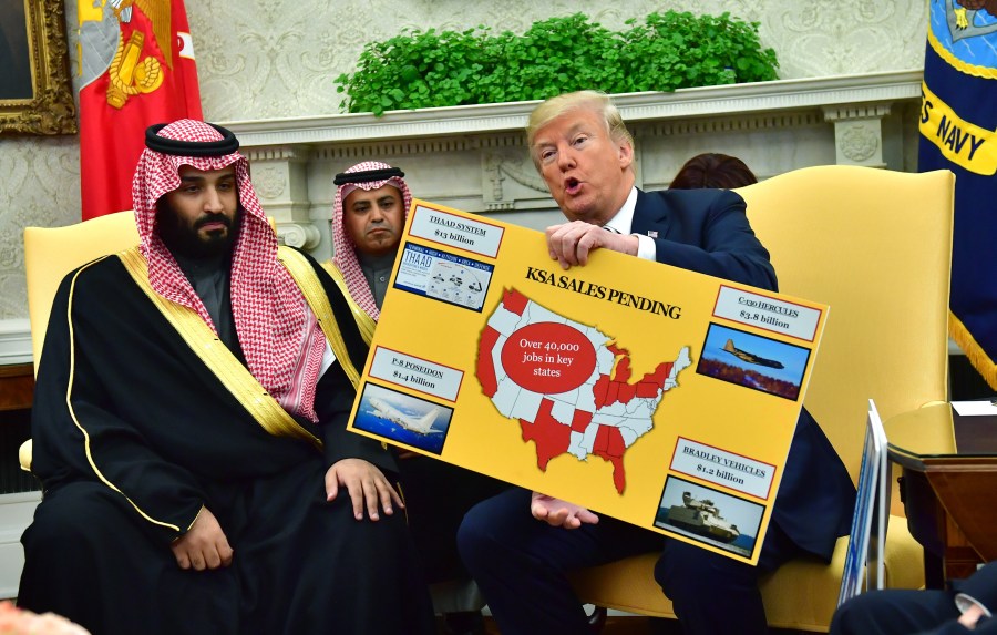 Donald Trump holds up a chart of military hardware sales as he meets with Crown Prince Mohammed bin Salman of Saudi Arabia at the White House on March 20, 2018, in Washington, D.C. (Credit: Kevin Dietsch-Pool/Getty Images)