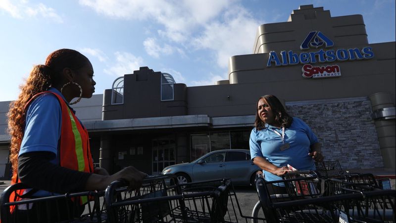 Pamela Hill, 58, right, talks with a co-worker about the possibility of another strike in front of the Albertsons store where she has worked at for the last 23 years in the Crenshaw District in Los Angeles in this undated photo. (Credit: Genaro Molina / Los Angeles Times)