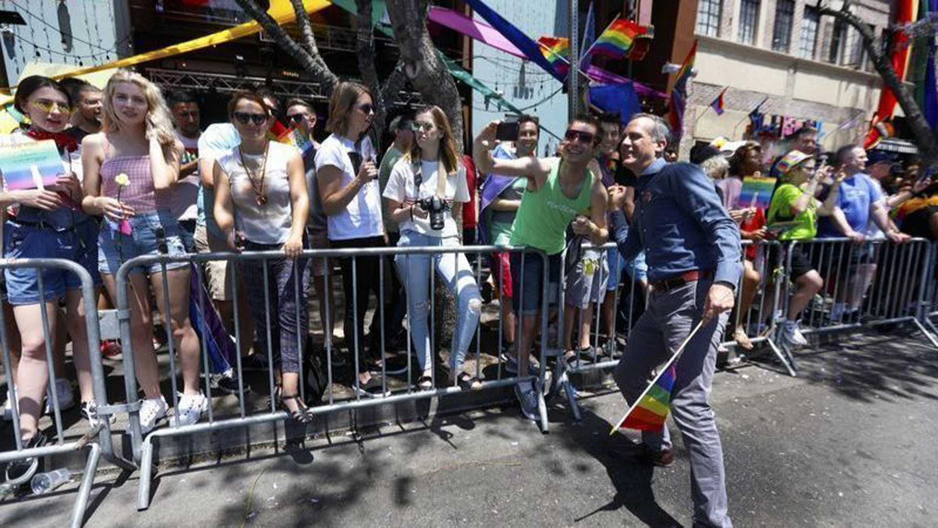 Los Angeles Mayor Eric Garcetti, right, greets the crowd at the 2018 LA Pride Parade in West Hollywood. (Credit: Francine Orr / Los Angeles Times)