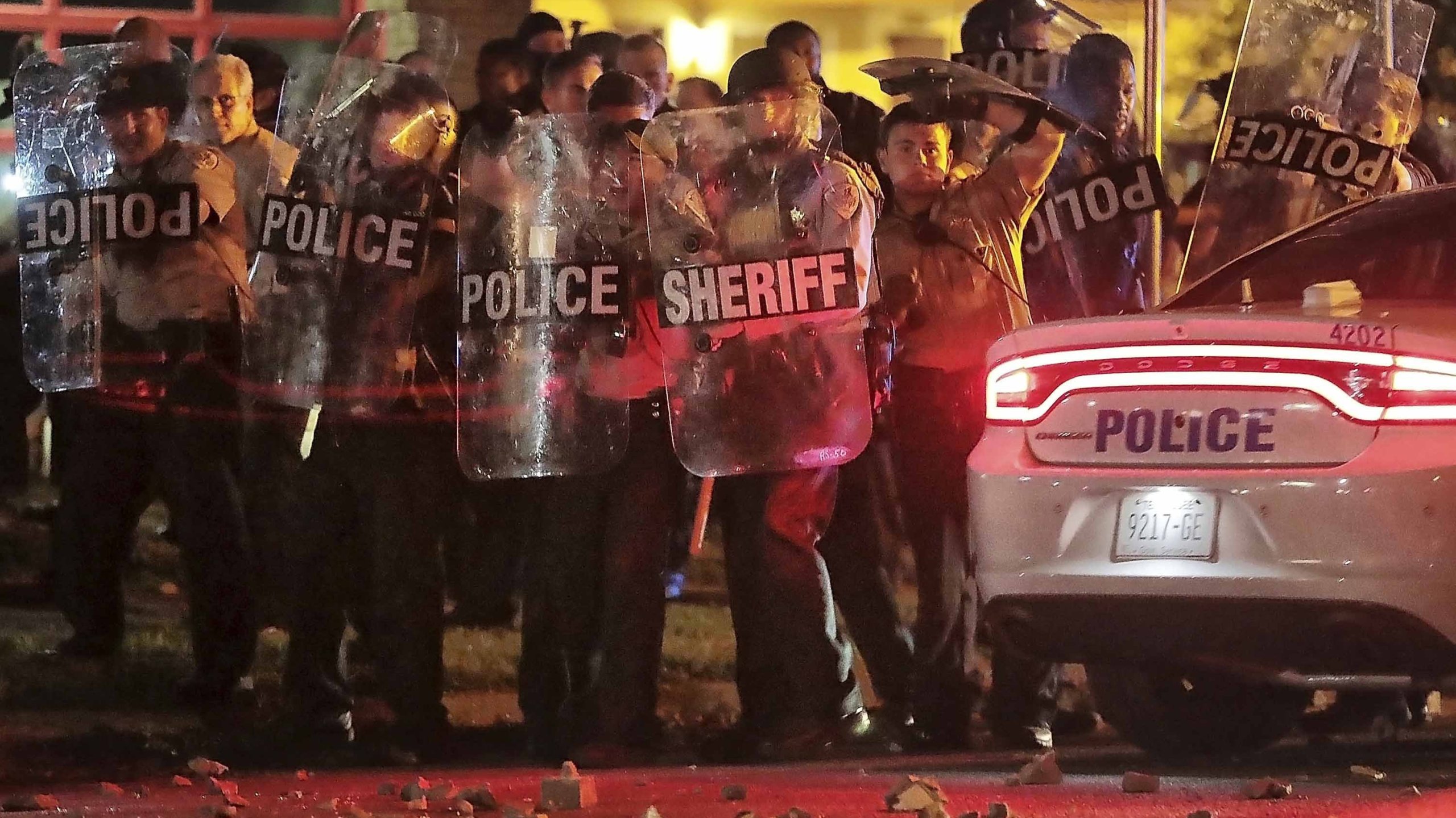 Shelby County Sheriff's deputies brace against the crowd as protesters throw rocks. (Credit: Jim Weber/AP via CNN Wire)