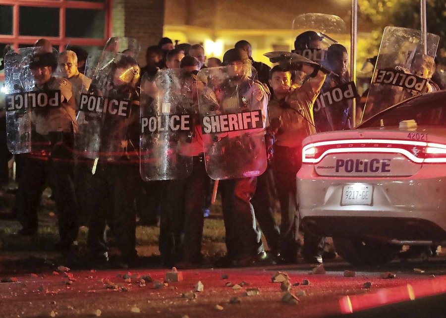 Shelby County Sheriff's deputies brace against the crowd as protesters throw rocks. (Credit: Jim Weber/AP via CNN Wire)