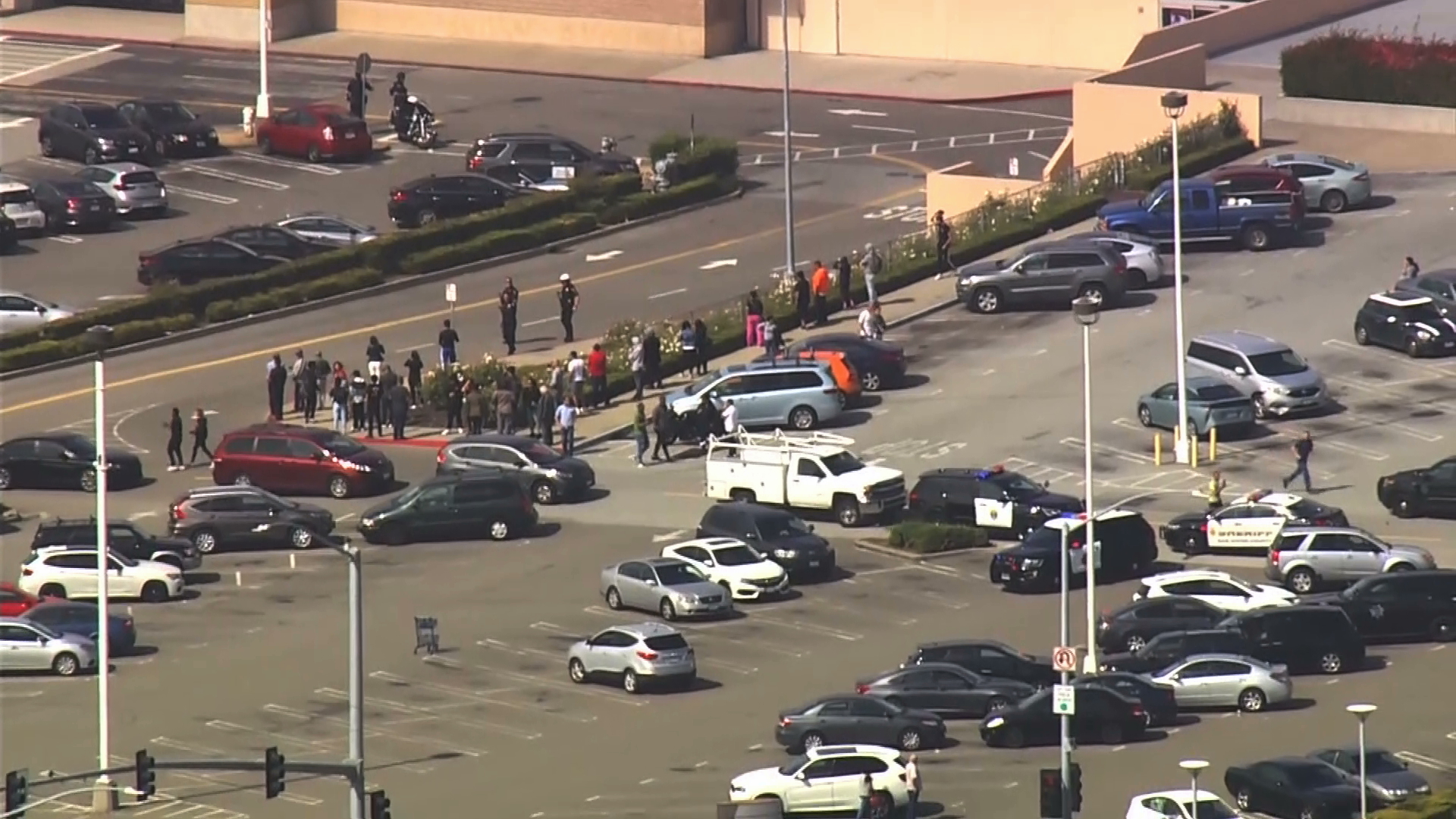 Shoppers flood the parking lot after a shooting at a mall in San Bruno, 10 miles south of San Francisco, on July 2, 2019. (Credit: KGO via CNN)