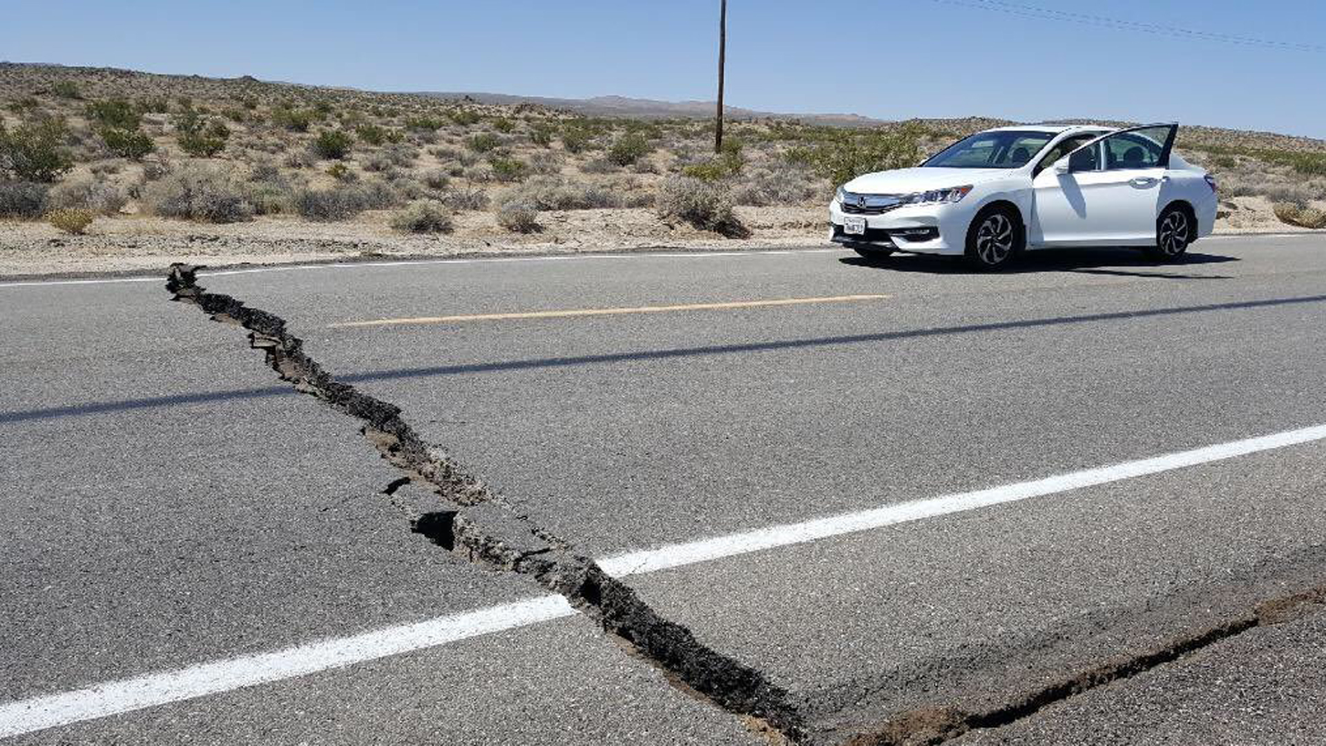 A large crack is seen going clear across a highway following an earthquake on July 4, 2019. (Credit: A crack in the road is seen near Ridgecrest, California after Thursday's quake. (Credit: Karaleigh Roe via CNN)