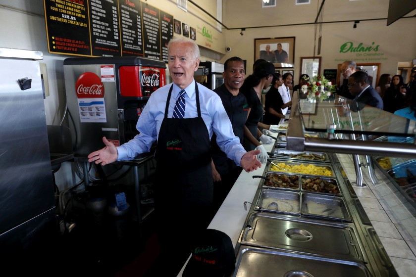 Joe Biden helps out behind the counter at Dulan’s in South L.A. on July 18, 2019. (Credit: Gary Coronado/Los Angeles Times)