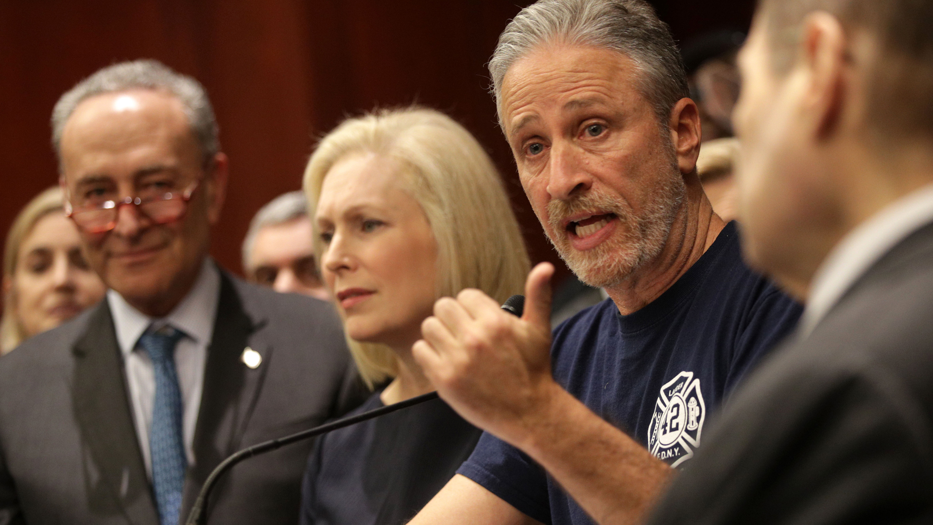 Jon Stewart is joined by senators, 9/11 first responders, survivors and their families as he speaks during a news conference on Feb. 25, 2019, in Washington, DC. (Credit: Alex Wong/Getty Images)