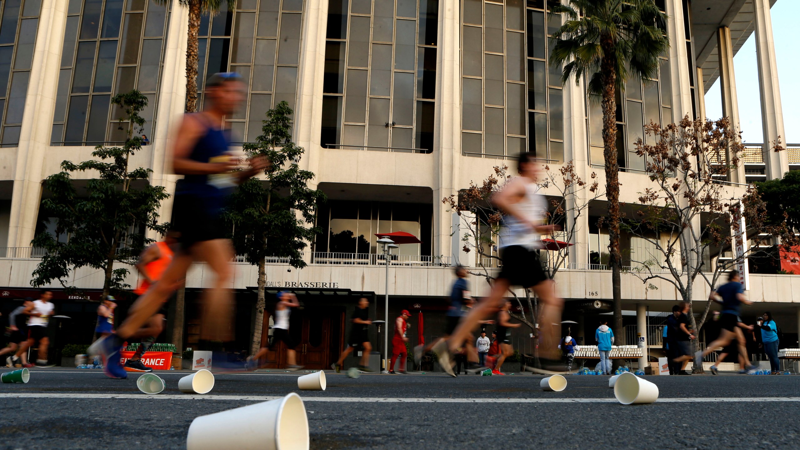 Competitors run past the Dorothy Chandler Pavilion during the 2019 Skechers Performance Los Angeles Marathon on March 24, 2019. (Credit: Katharine Lotze / Getty Images)