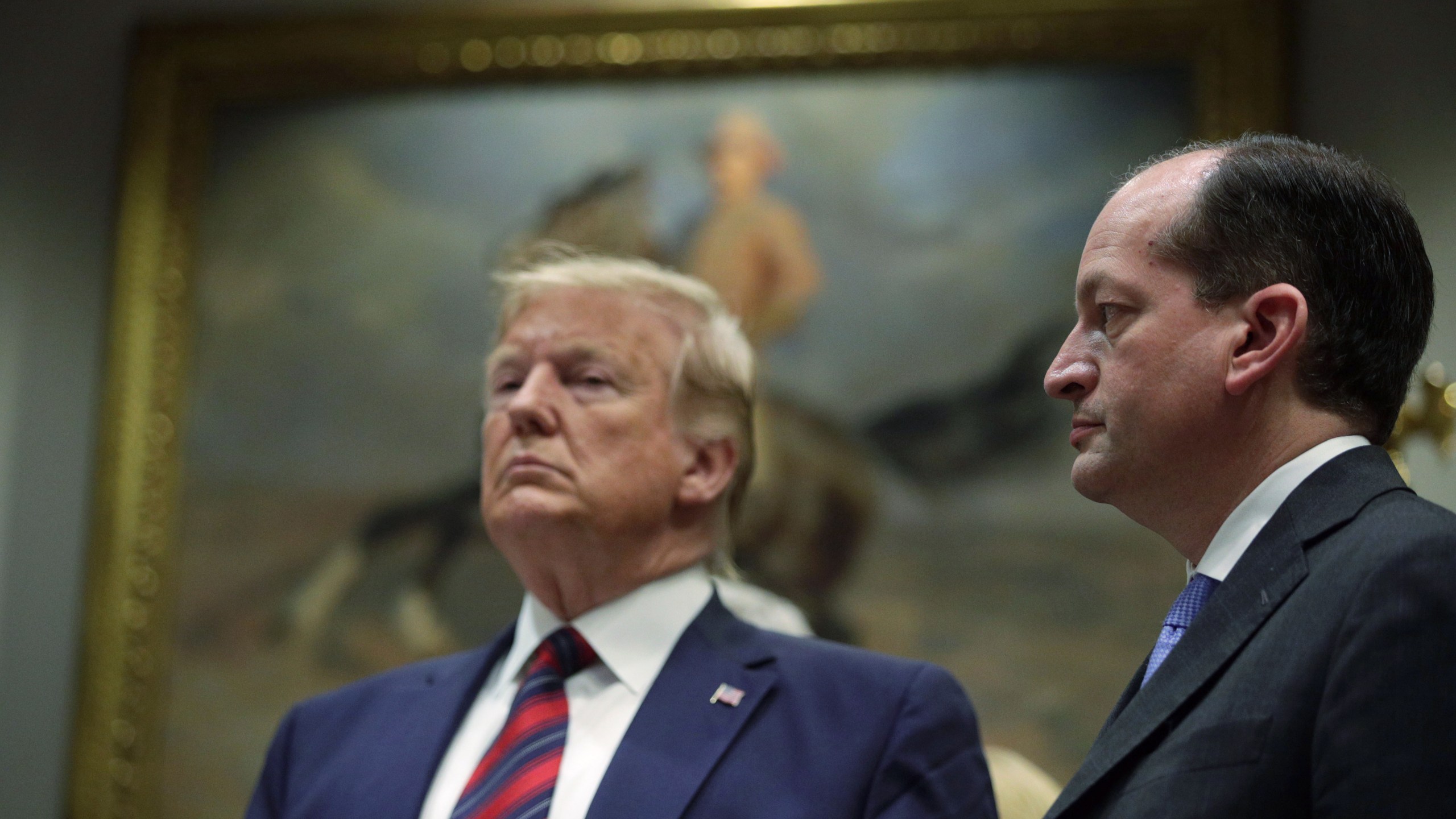 Donald Trump and Secretary of Labor Alexander Acosta listen during a Roosevelt Room event at the White House on May 9, 2019. (Credit: Alex Wong/Getty Images)